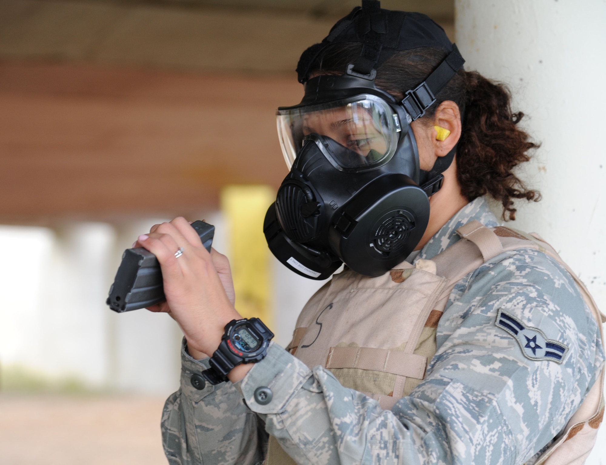 U.S. Air Force Airman 1st Class Tiana Zakariyyaa, 633rd Security Forces Squadron member, counts the bullets in an M4 carbine magazine while wearing a gas mask at Langley Air Force Base, Va., Nov. 1, 2012. The shooting exercise was held to assess how accurately security personal score on the qualifications, through various challenges. (U.S. Air Force photo by Airman 1st Class Victoria Taylor/Released)
