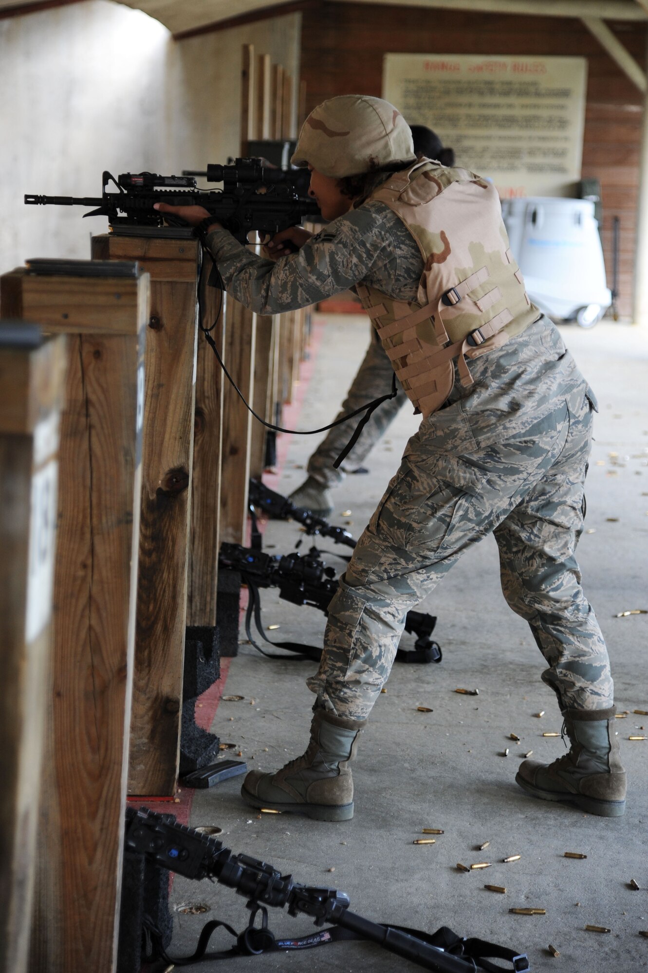 U.S. Air Force Airman 1st Class Tiana Zakariyyaa, 633rd Security Forces Squadron member, aims her weapon toward a stationary target at Langley Air Force Base, Va., Nov. 1, 2012. Security personnel must maintain a qualifying score while shooting their weapons.  (U.S. Air Force photo by Airman 1st Class Victoria Taylor/Released)