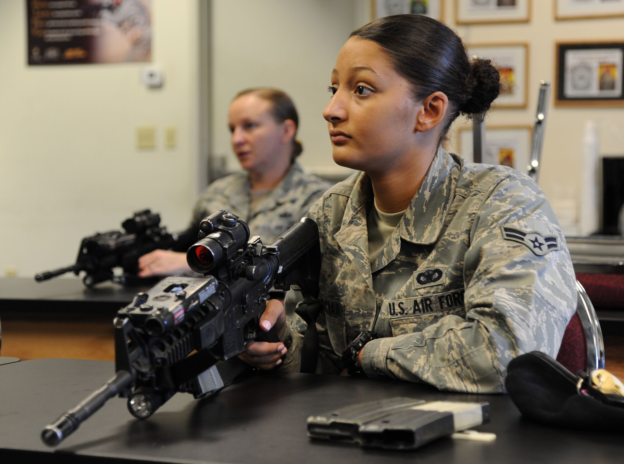 U.S. Air Force Airman 1st Class Tiana Zakariyyaa, 633rd Security Forces Squadron member, participates in a weapons class at Langley Air Force Base, Va., Nov. 1, 2012. The course began with weapons safety and other refresher information.  (U.S. Air Force photo by Airman 1st Class Victoria Taylor/Released)