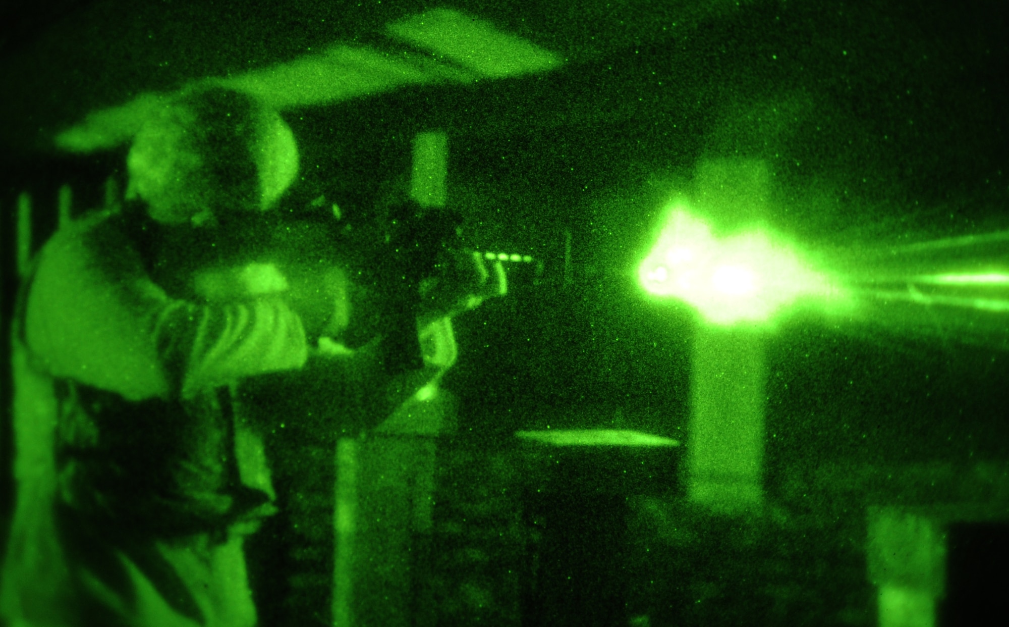 Desmond Moore, 633rd Security Forces Squadron police officer, fires a 5.56mm M4 Carbine with a night vision scope at Langley Air Force Base, Va., Nov. 1, 2012. Security personnel gained experience using night vision during a routine-firing qualification assessment. (U.S. Air Force photo by Senior Airman Racheal E. Watson/Released)
