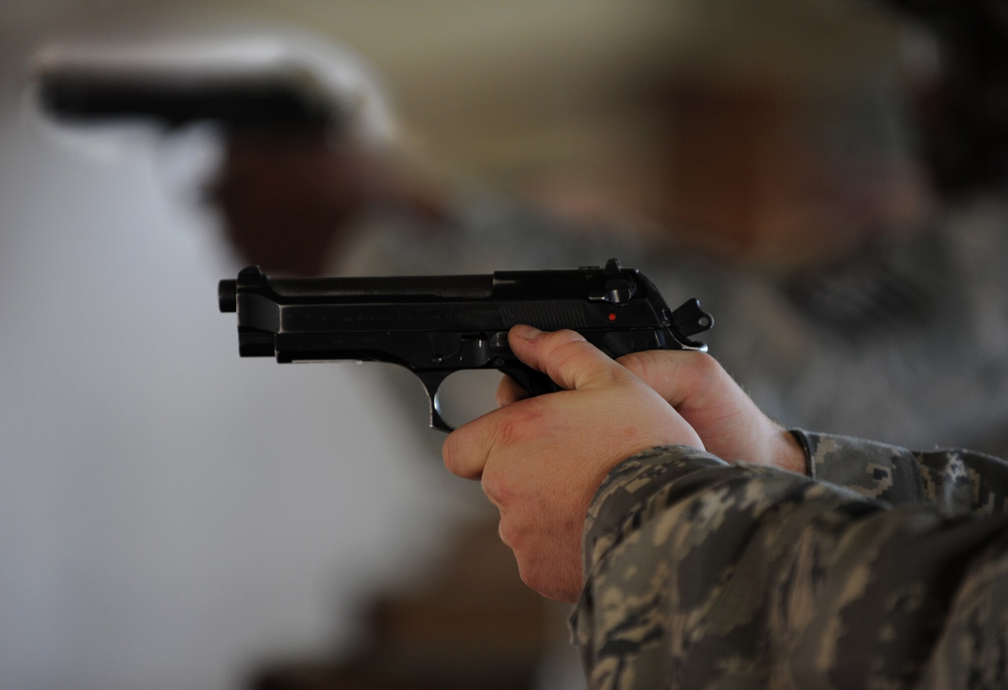 U.S. Air Force Staff Sgt. Mathew Delmonico, 633rd Security Forces Squadron response force leader, fires a 9mm M9 Beretta at Langley Air Force Base, Va., Nov. 1, 2012. Security Forces personnel access their accuracy through qualification tests. (U.S. Air Force photo by Senior Airman Racheal E. Watson/Released)