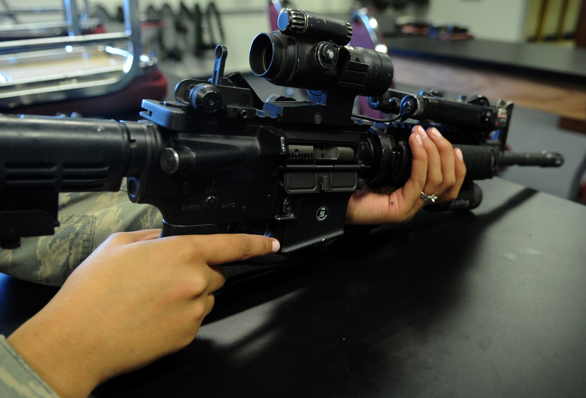 U.S. Air Force Airman 1st Class Tiana Zakariyya, 633rd Security Forces Squadron member, demonstrates weapon safety during Combat Arms Training and Maintenance classroom training at Langley Air Force Base, Va., Nov. 1, 2012. Security Forces personnel partook in a routine safety class to ensure proper handling of weapons and safety measures. (U.S. Air Force photo by Senior Airman Racheal E. Watson/Released)