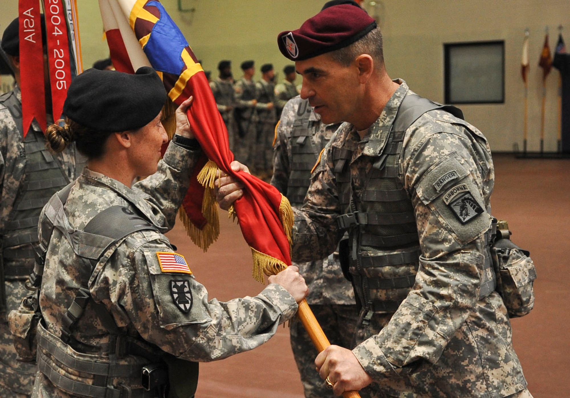 Brigadier General Jeffrey N. Colt, right, 18th Airborne Corps deputy commanding general, hands the 7th Sustainment Brigade colors to Col. Jennifer A. Reinkober during the 7th Sustainment Brigade change-of-command ceremony Nov.1, 2012, at McClellan Gym at Fort Eustis, Va. Colonel Lawrence Kominiak relinquished command to Reinkober in a tradition known as the passing of the colors, which symbolizes the passing of command authority between commanders. (U.S. Air Force photo by Staff Sgt. Wesley Farnsworth/Released)