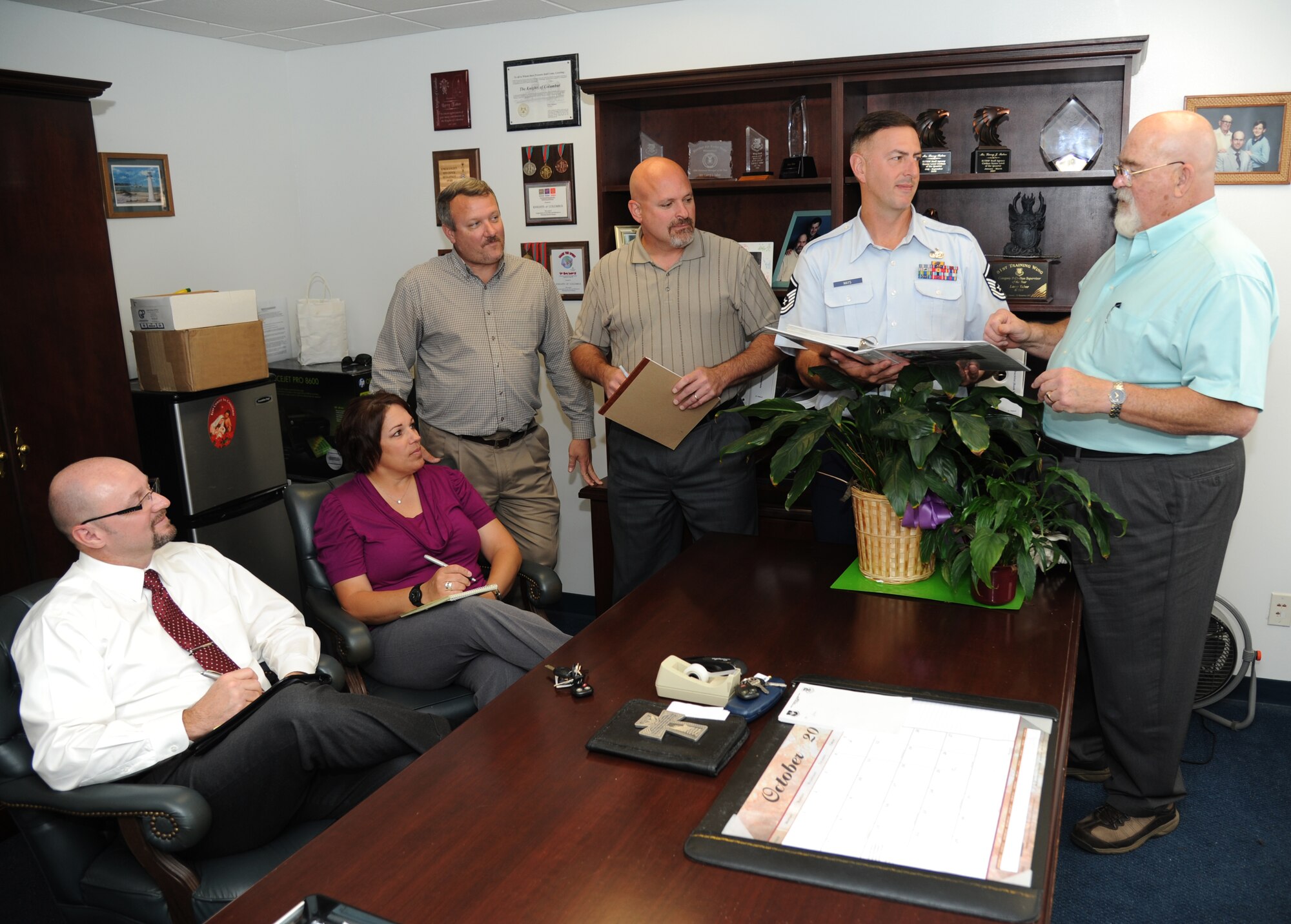 Don Young, Kristina Keeton, Thane Halsey, Scott Lucas and Master Sgt. Bill Mays, 81st Training Wing, take notes and listen as Larry Tabor, 81st TRW Plans and Programs Office chief and installation antiterrorism officer, reviews the wing antiterrorism plan Nov. 5, 2012, in his office at the 81st TRW Headquarters building, Keesler Air Force Base, Miss.  Tabor will retire after 41 years of federal service Nov. 16 during a ceremony at the Bay Breeze Event Center.  (U.S. Air Force photo by Kemberly Groue)