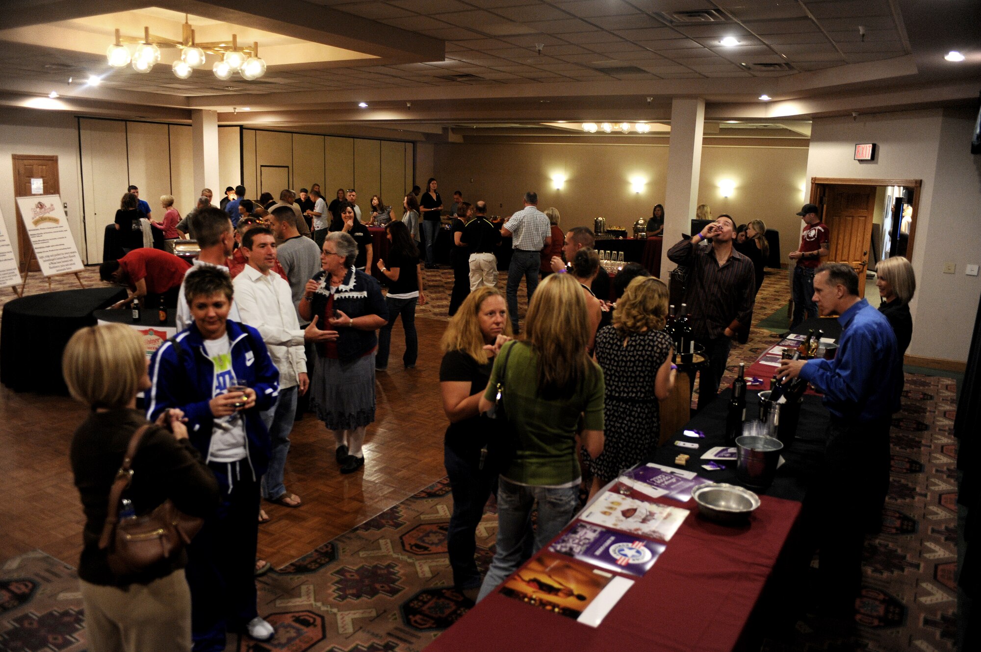 Members of the Cannon community socialize during the Raise Your Glass event held at the Landing Zone at Cannon Air Force Base, N.M., Nov.2, 2012. The event was held for active duty military, veterans and dependents of age to sample a variety of wine and beer. (U.S. Air Force photo/Airman 1st Class Xavier Lockley)