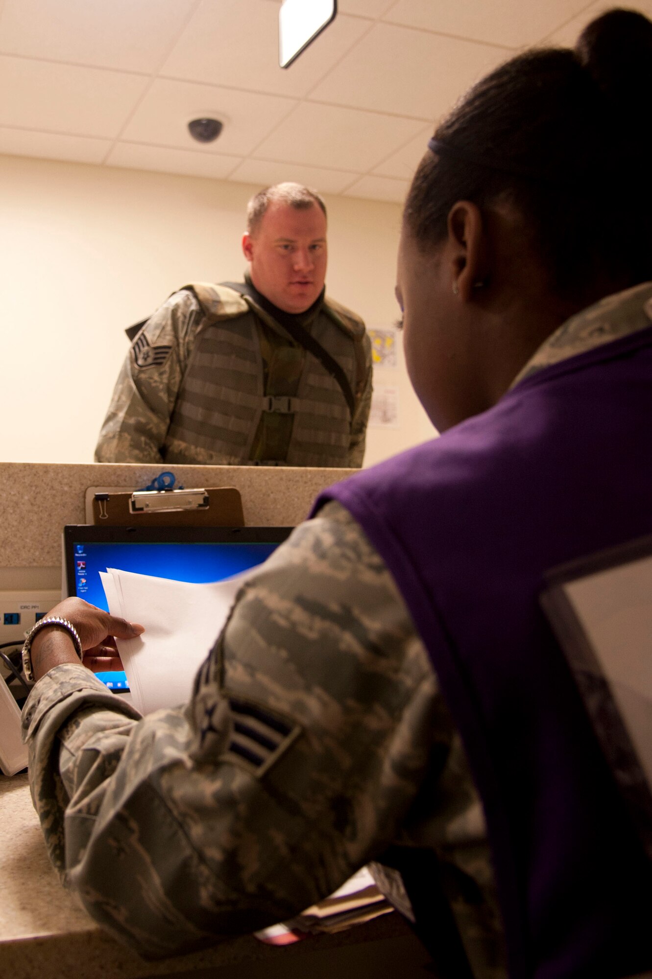 VANDENBERG AIR FORCE BASE, Calif. – Senior Airman Monique Bailey, 30th Force Support Squadron customer support journeyman, checks forms during a Personnel Deployment Function at the Installation Deployment Readiness Center here Friday, Nov. 2, 2012. Deployment lines consist of deployment folder checks, finance information, Airman and Family Readiness information for deployers and their families, medical checks and briefings. (U.S. Air Force photo/Senior Airman Lael Huss)