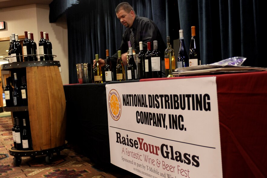 A local vendor prepares a table full of assorted wines for the Raise Your Glass event at Cannon Air Force Base, N.M., Nov.2, 2012. The event was held for active duty military, veterans and dependents of age to sample a variety of wine and beer. (U.S. Air Force photo/Airman 1st Class Xavier Lockley)