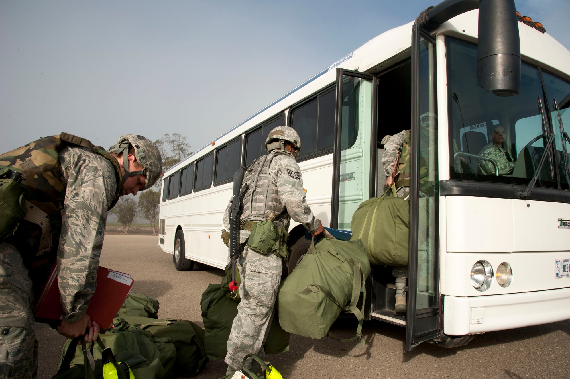 VANDENBERG AIR FORCE BASE, Calif. – Team V Northstar deployers load onto a bus headed for the Personnel Deployment Function line at the parade grounds here Friday, Nov. 2, 2012. The PDF line is a way for Airmen to ensure that they have everything they need and are cleared to deploy. (U.S. Air Force photo/Senior Airman Lael Huss)
