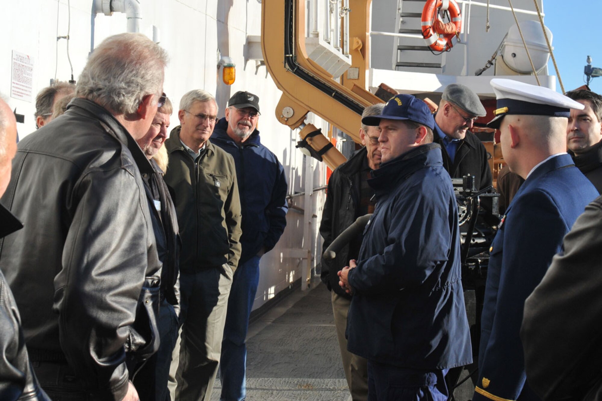 Commander Ben Strickland, U.S. Coast Guard Cutter Munro executive officer, welcomes Alaskan Command Civilian Advisory Board members.  During their visit to Kodiak, the ALCOM CAB toured the Munro, the Navy Seals cold-weather training facility, and received briefings on the role of the Coast Guard in Alaska.  (U.S. Air Force photo/Tommie Baker)
