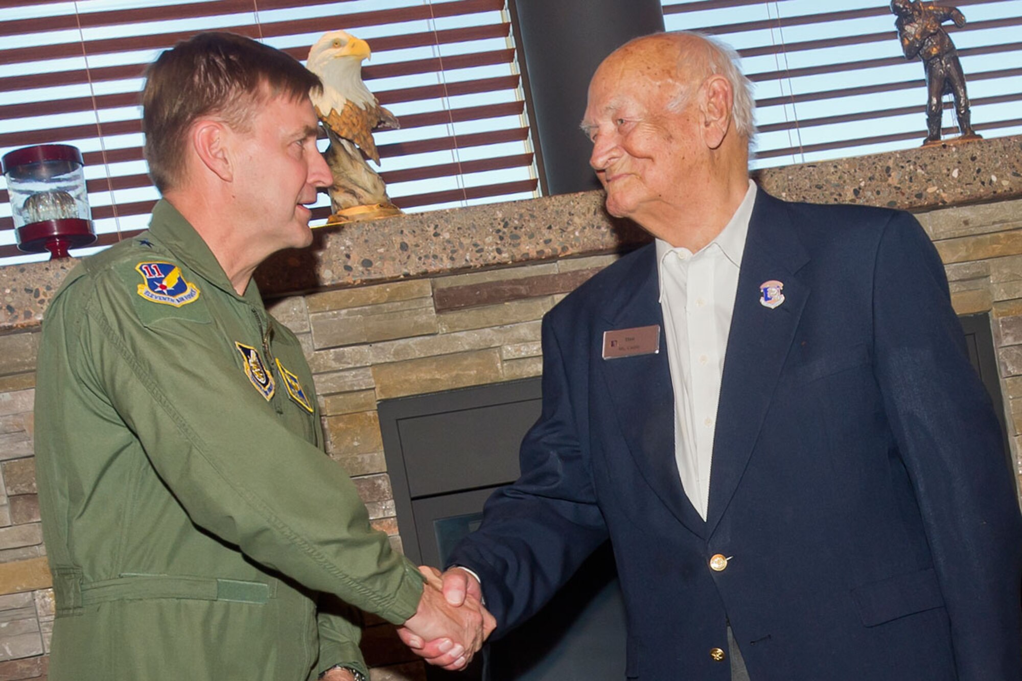 Lt. Gen. Steve Hoog, commander of Alaskan Command, congratulates and thanks ALCOM Civilian Advisory Board member Daniel Cuddy for his more than 50 years of continued service to the command.  The ALCOM CAB was established in 1962 as a means to build communication between service members in Alaska and surrounding communities. (U.S. Air Force photo/Justin Connaher)
