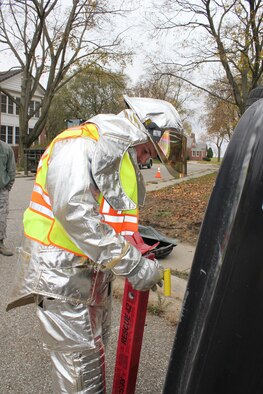 Airman 1st Class Scott Simmerson responds to a staged roll-over vehicle accident while training with the 127th Civil Engineer Squadron fire department at Selfridge Air National Guard Base, Mich., Nov. 4, 2012. Base fire fighters are trained to respond to traffic accidents, structure fires and other emergency calls, in addition to being trained in specialized response to aircraft incidents. (Air National Guard photo by SSgt. Samara Taylor)