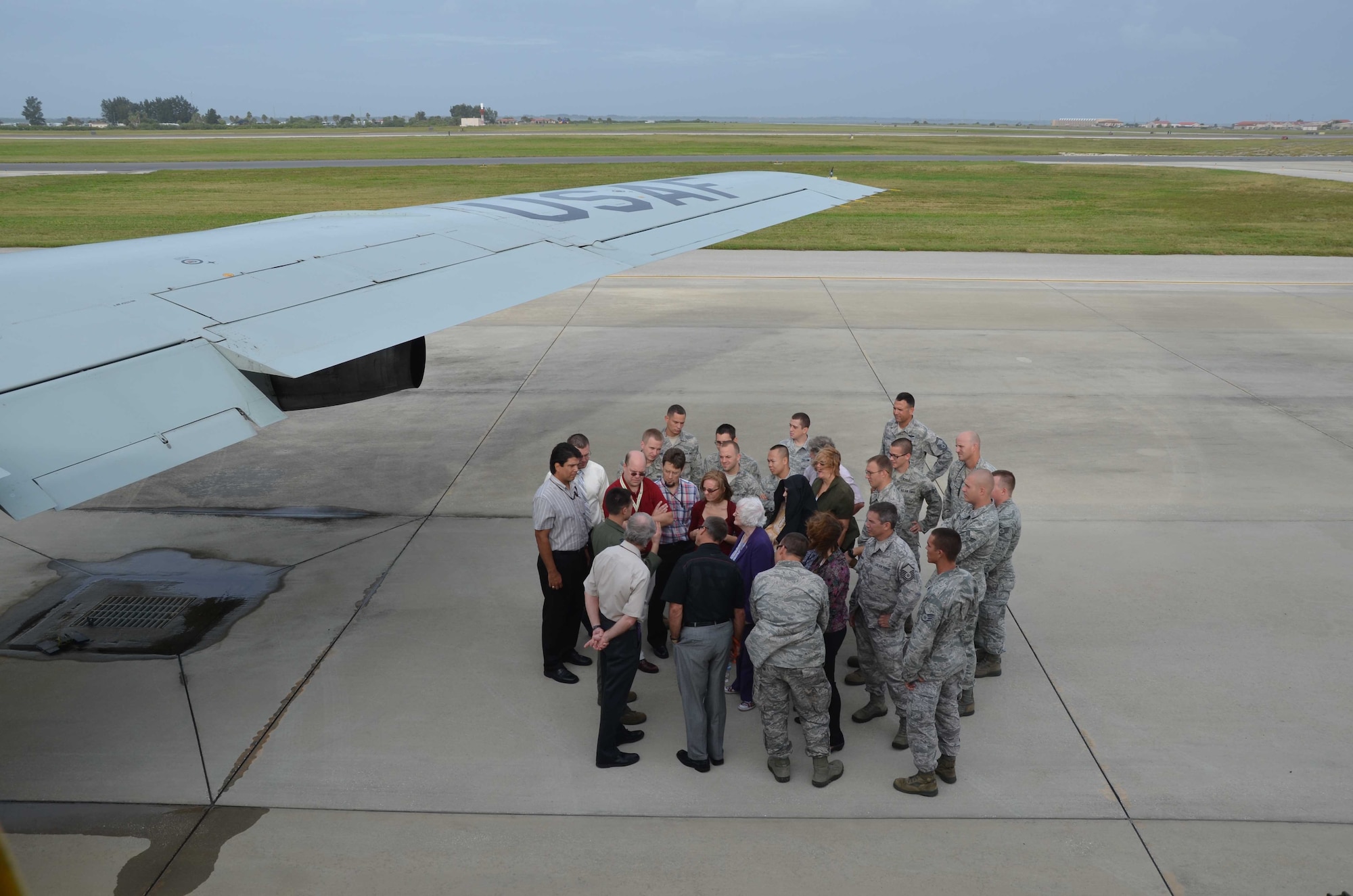 A group of visitors is briefed on the capabilities of the WC-135 Constant Phoenix Oct. 25, 2102.  The jet was on display at Patrick AFB, Fla., for members of the Air Force Technical Applications Center and the 45th Space Wing.  As people made their way through and around the aircraft, crewmembers discussed the features and capabilities of the atmospheric collection suite, which allows the mission crew to detect radioactive ‘clouds’ in real time.  (U.S. Air Force photo by Susan A. Romano)

