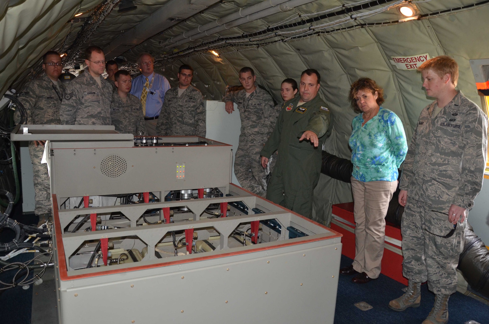 Tech. Sgt. Paul Carpenter (center) briefs visitors aboard the WC-135 Constant Phoenix Oct. 25, 2012 on the aircraft's capabilities.  Here, he describes how the whole air gas collection systems operates.  The jet, which is permanently stationed at Offutt AFB, Neb., supports the U.S. Atomic Energy Detection System.  (U.S. Air Force photo by Susan A. Romano)