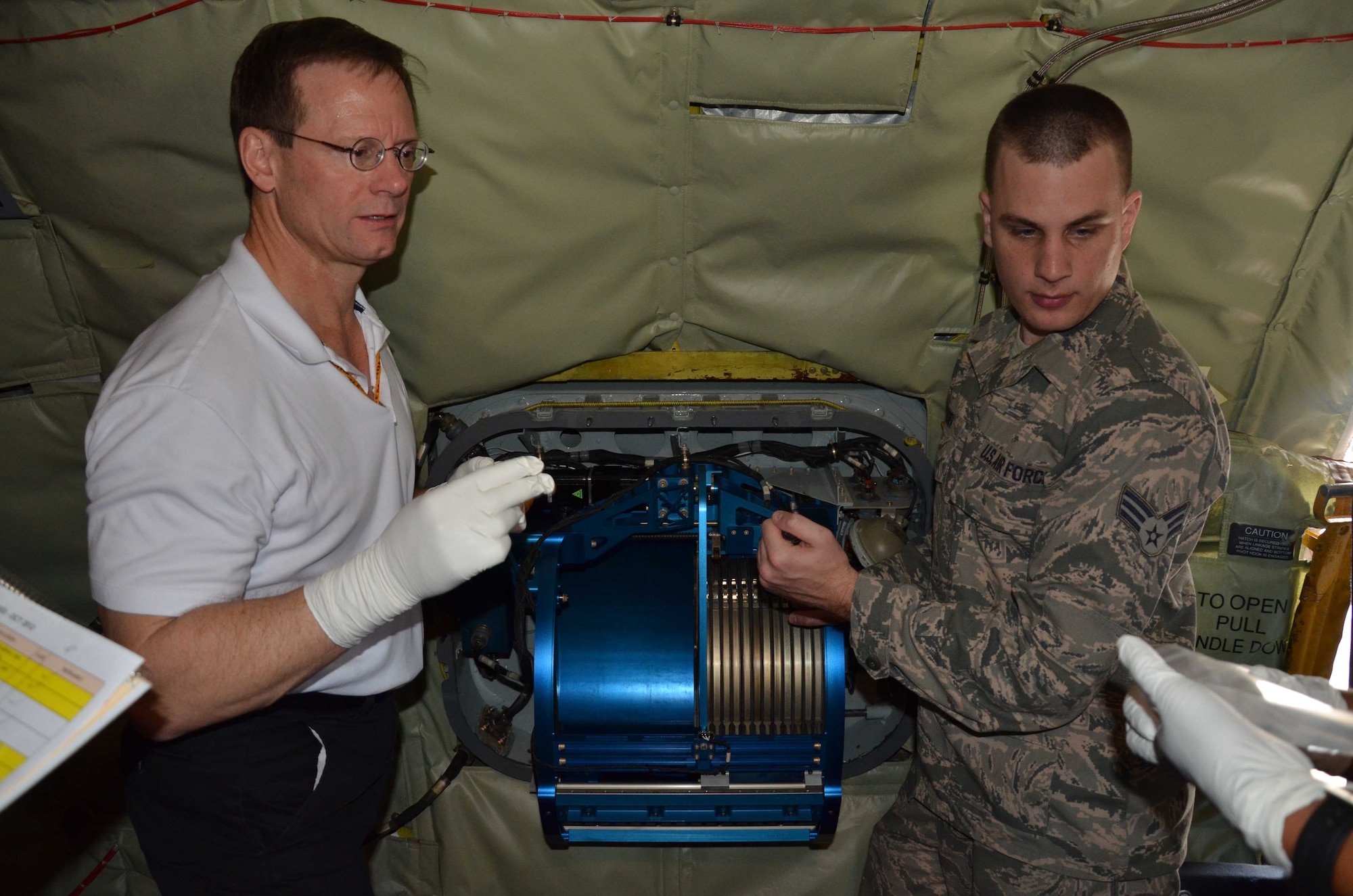 William Harris (left) and Senior Airman Chris Lussier prepare to collect swipe samples aboard the WC-135 Constant Phoenix to determine if residue material is present that could affect the integrity of operational samples. The aircraft was on display at Patrick AFB, Fla., Oct. 25, 2012 to give Air Force Technical Applications Center and 45th Space Wing personnel the opportunity to tour the jet.  The aircraft is permanently stationed at Offutt AFB, Neb., and its mission crew is responsible for operating and maintaining the advanced atmospheric research equipment aboard in support of the U.S. Atomic Energy Detection System.  (U.S. Air Force photo by Susan A. Romano)