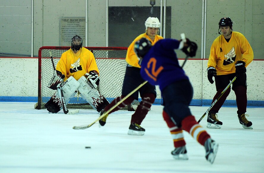 An Offutt Marauders hockey player takes a shot at the net guarded by U.S. Air Force Staff Sgt. Will Clouse, Offutt Marauders Division 1 goalie, during a scrimmage between the Division 1 and Division 3 teams at the Motto McLean Ice Arena in Omaha, Neb., Oct. 21. The Marauders consist of 40 players from Team Offutt who serve in officer, enlisted and civilian positions in a various roles in many Offutt organizations. (U.S. Air Force photo by Josh Plueger/Released)