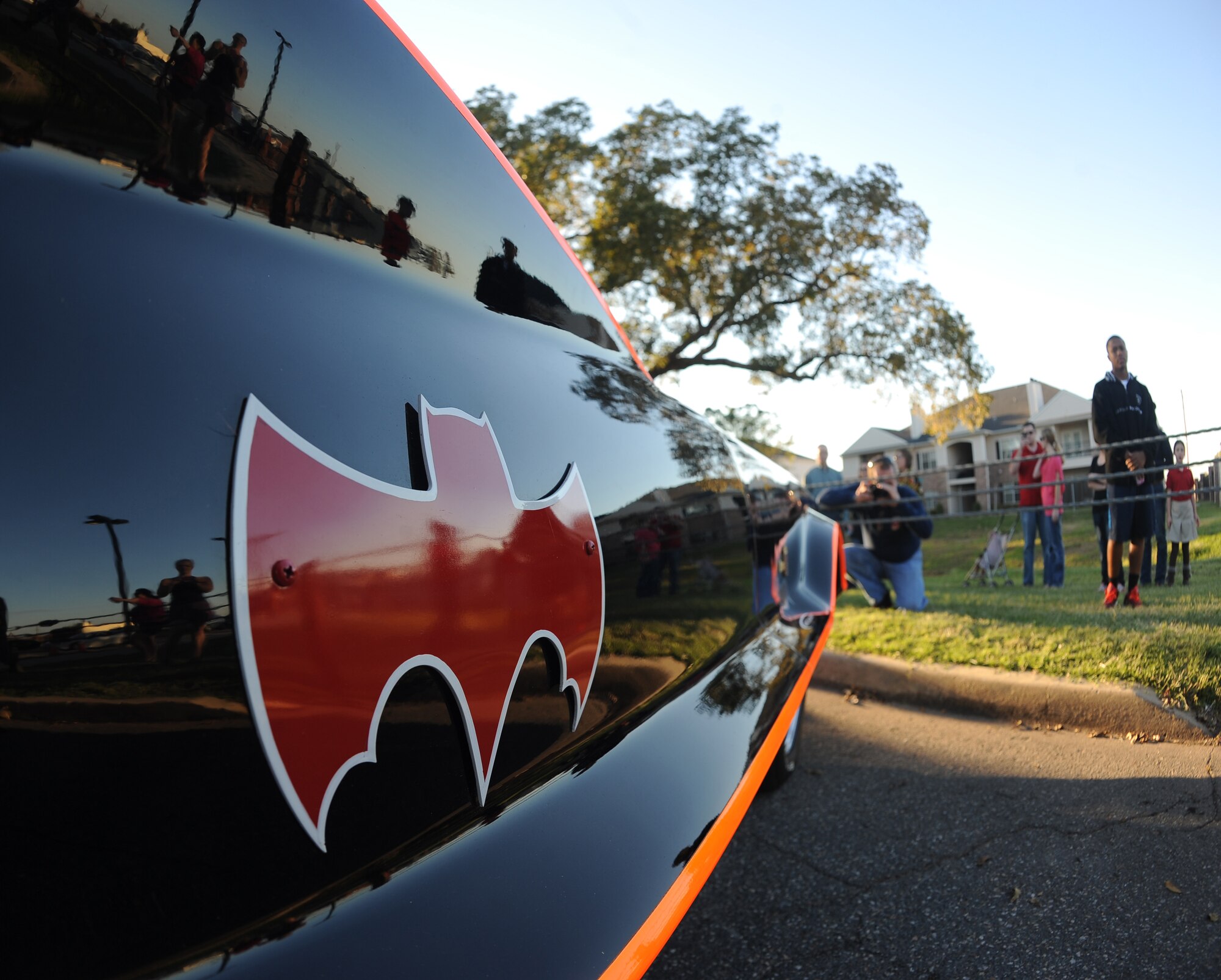 Members of Team Barksdale look at the Batmobile from the 1966 Batman TV series on display at the Barksdale Club parking lot on Barksdale Air Force Base, La., Oct. 30. The final paint job consisted of 40 coats of super gloss black. Five other Batmobiles and the Bat-Pod were brought to the base for Team Barksdale to enjoy. (U.S. Air Force photo/Senior Airman Micaiah Anthony)(RELEASED)