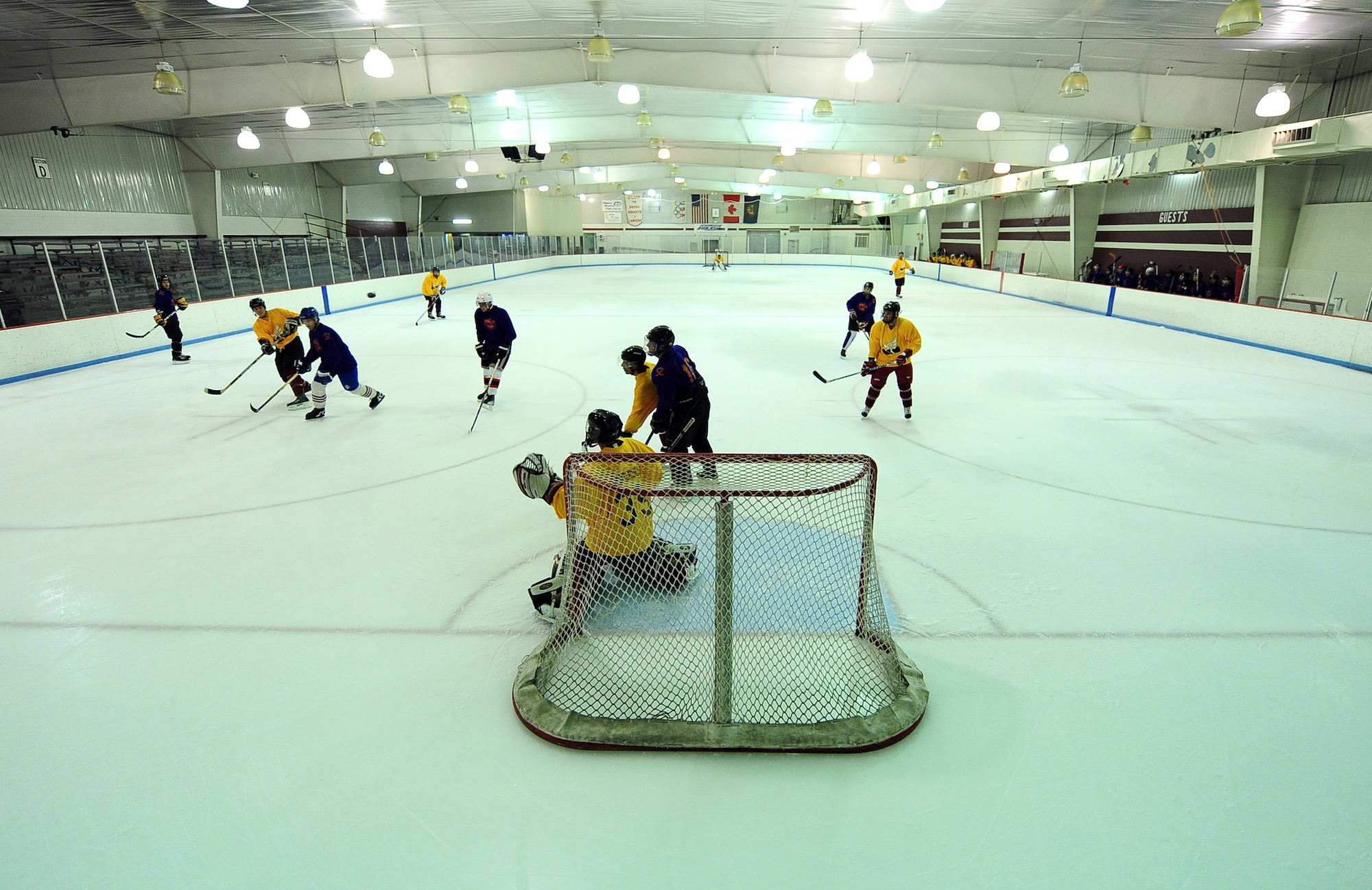 The Offutt Marauders watch a high puck soar towards the net during a scrimmage between the Offutt Marauders Division 1 and Division 3 hockey team at the Motto McLean Ice Arena in Omaha, Neb., Oct. 21. The teams practice with each other three times a month on Friday nights in preparation for their debut participation at the 10th Annual Armed Services Hockey Association Classic in Las Vegas, Nov. 8 - 11. (U.S. Air Force photo by Josh Plueger/Released)