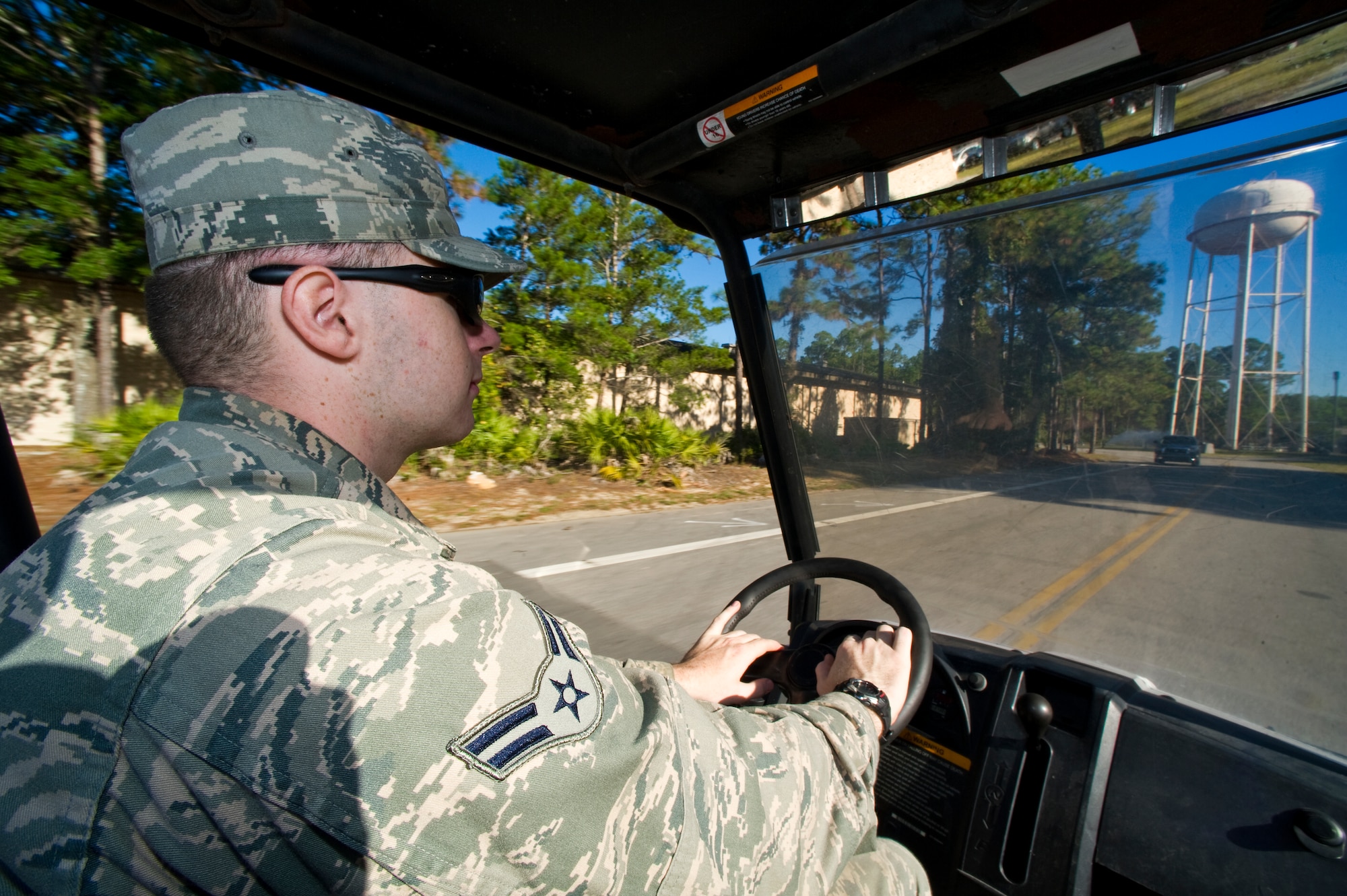 U.S. Air Force Airman 1st Class Joseph Bartha, cyber systems operator from 1st Special Operations Communications Squadron, drives a Bobcat vehicle for base beautification duty on Hurlburt Field, Fla., Oct. 25, 2012. Base beautification detail spends a week picking up trash on the base to help keep clean. (U.S. Air Force photo/Airman 1st Class Christopher Williams)