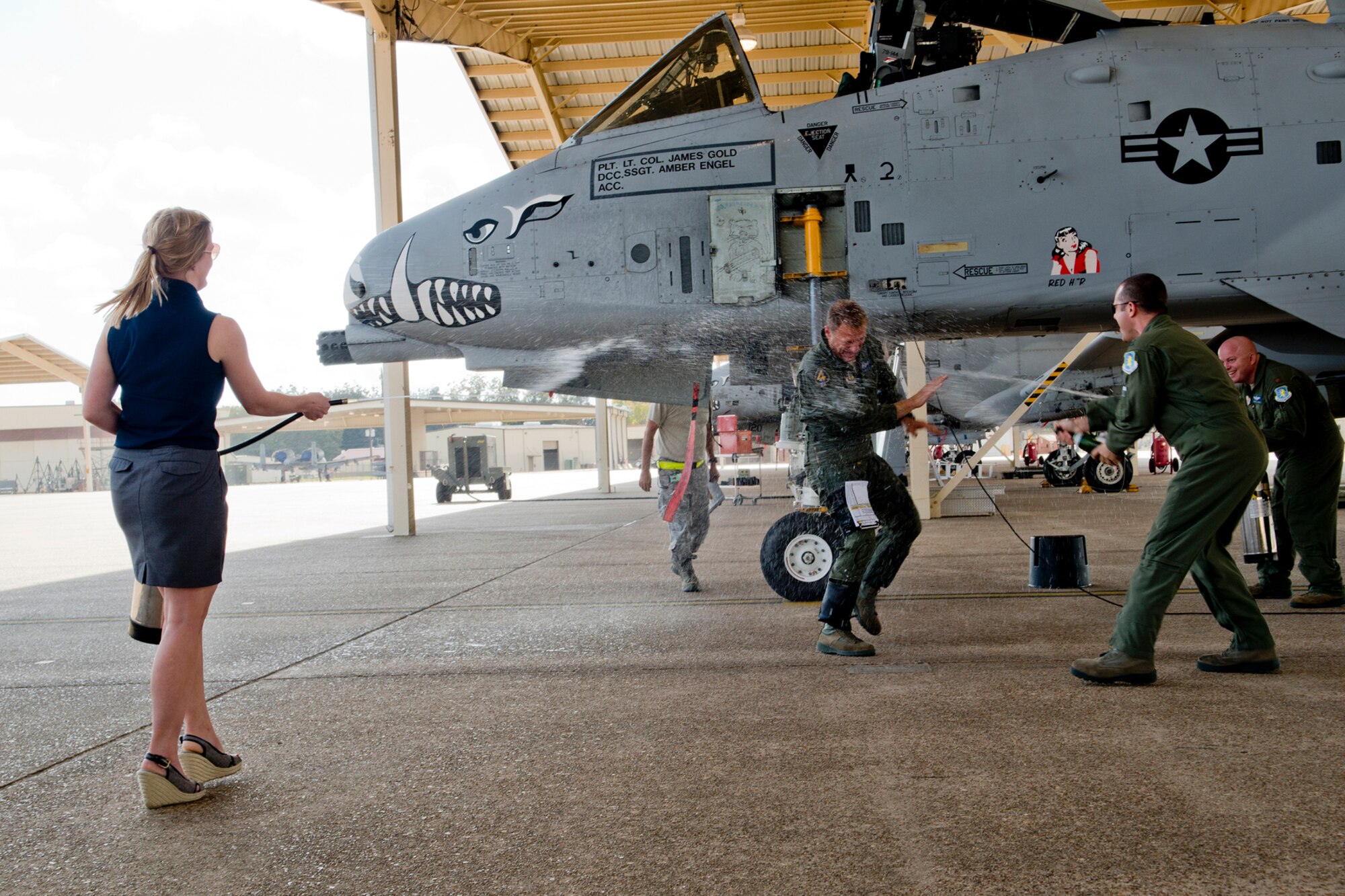 U.S. Air Force Lt.. Col. Rodney Glass, 917th Fighter Group deputy commander, is hosed down by his daughter Amanda and members of the 47th Fighter Squadron after his return from his last sortie in the A-10 Thunderbolt II, Nov. 3, 2012, Barksdale Air Force Base, La. Glass is retiring from the Air Force after serving 28 years. (U.S. Air Force photo by Master Sgt. Greg Steele/Released)