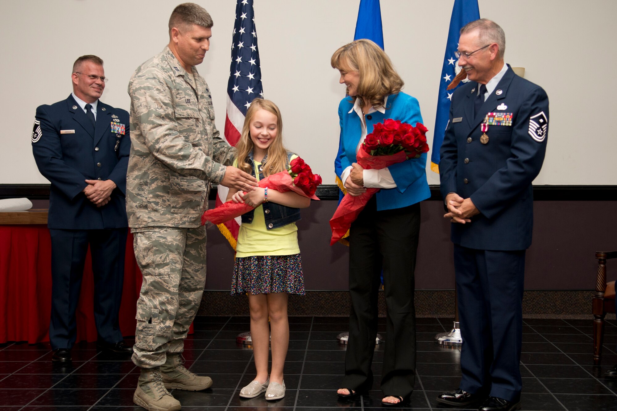 U.S. Air Force Capt. Mark Lee, 307th Security Forces Squadron commander, presents a bouquet of roses to Master Sgt. Jim Taliaferro's wife Janet and daughter Kate during a retirement ceremony on Nov. 3, 2012, Barksdale Air Force Base, La. Taliaferro is retiring from the Air Force Reserve after serving 31 years in the military. (U.S. Air Force photo by Master Sgt. Greg Steele/Released)