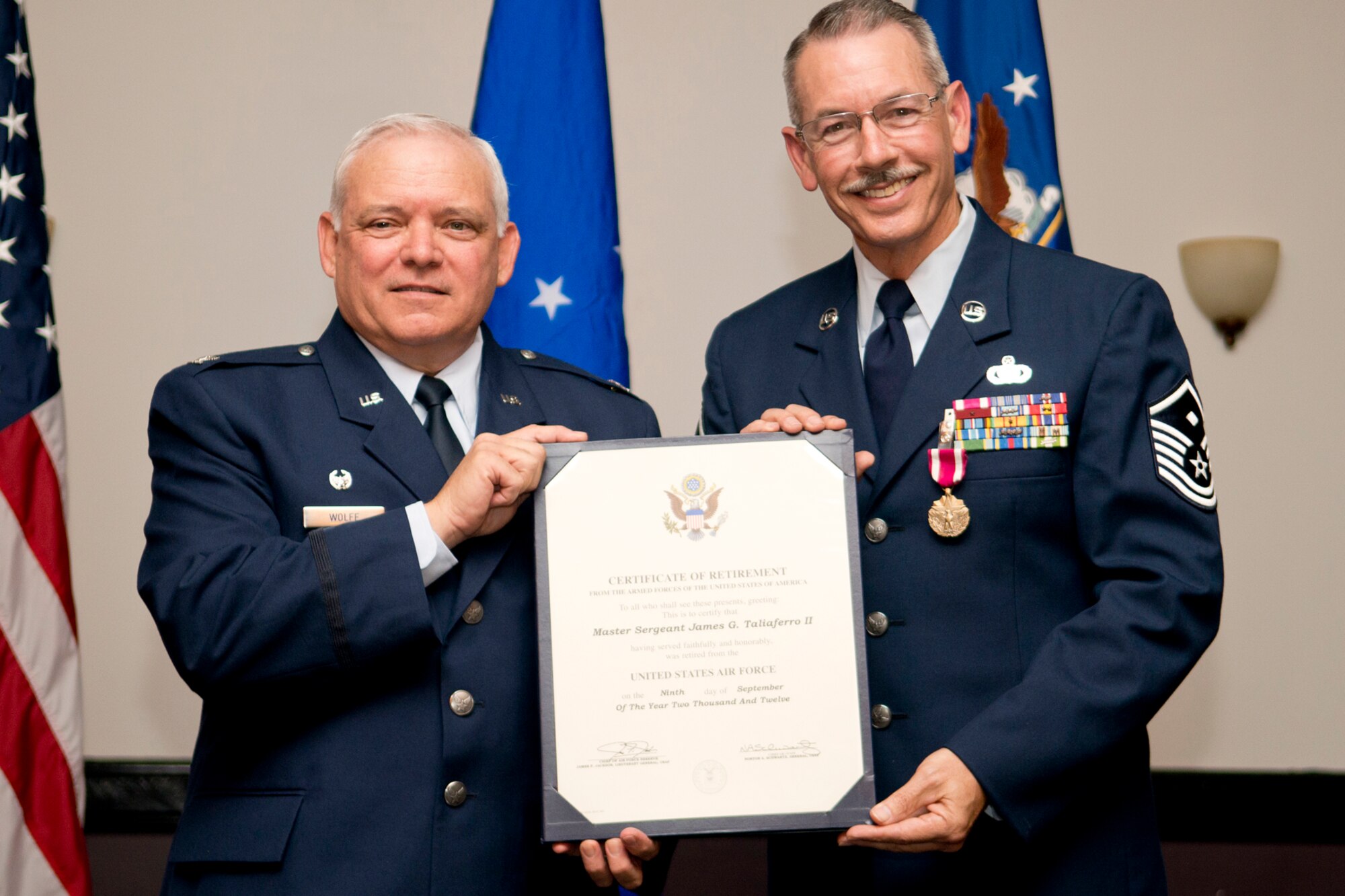 U.S. Air Force Col. Kevin Wolfe, 307th Mission Support Group commander, presents a Retirement Certificate to Master Sgt. Jim Taliaferro during a ceremony on Nov. 3, 2012, Barksdale Air Force Base, La. Taliaferro is the First Sergeant assigned to the 307th Security Forces Squadron and is retiring after serving 31 years in the military. (U.S. Air Force photo by Master Sgt. Greg Steele/Released)