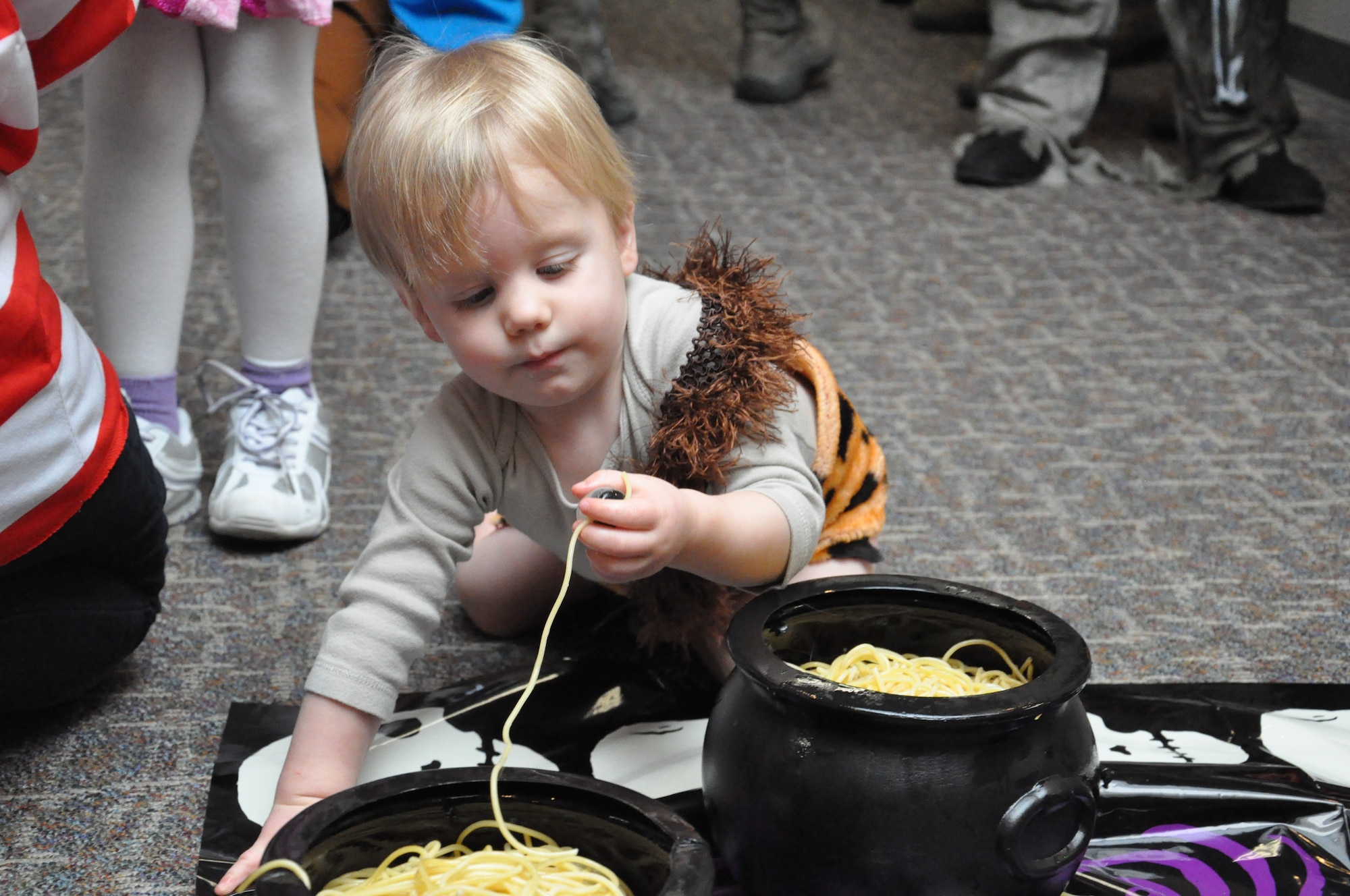 BUCKLEY AIR FORCE BASE, Colo. – A child digs through simulated guts to find a fake eyeball Oct. 31, 2012, at the 460th Space Communications Squadron Halloween event. The children also wandered the building to trick-or-treat. (U.S. Air Force photo by Staff Sgt. Nicholas Rau)