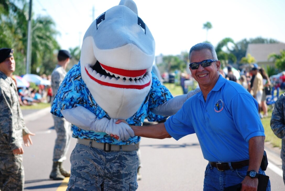 Col. Ed  Rivera, 45th Space Wing Safety Chief, shakes hands with the 45th Space Wing mascot, “Snark” during the annual Founder’s Day Parade held in Satellite Beach Saturday morning. 
		


