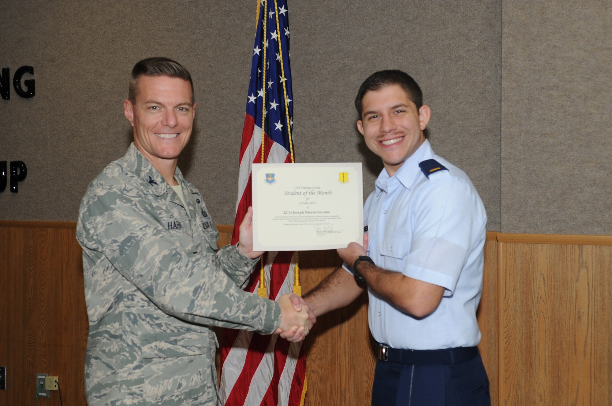 U.S. Air Force Col. Brendan Harris, 17th Training Group commander, presents 2d Lt. Joseph Nieves-Serrano with the 315th Training Squadron Officer Student of the Month award for October at Goodfellow Air Force Base, Texas, Nov. 2, 2012. (U.S. Air Force photo by Staff Sgt. Laura R. McFarlane)