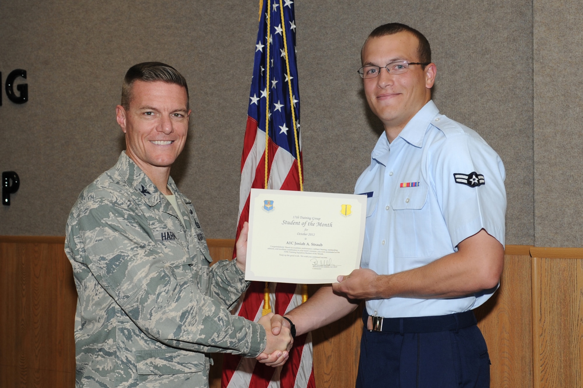 U.S. Air Force Col. Brendan Harris, 17th Training Group commander, presents Airman 1st Class Josiah Straub with the 315th Training Squadron Enlisted Student of the Month award for October at Goodfellow Air Force Base, Texas, Nov. 2, 2012. (U.S. Air Force photo by Staff Sgt. Laura R. McFarlane)