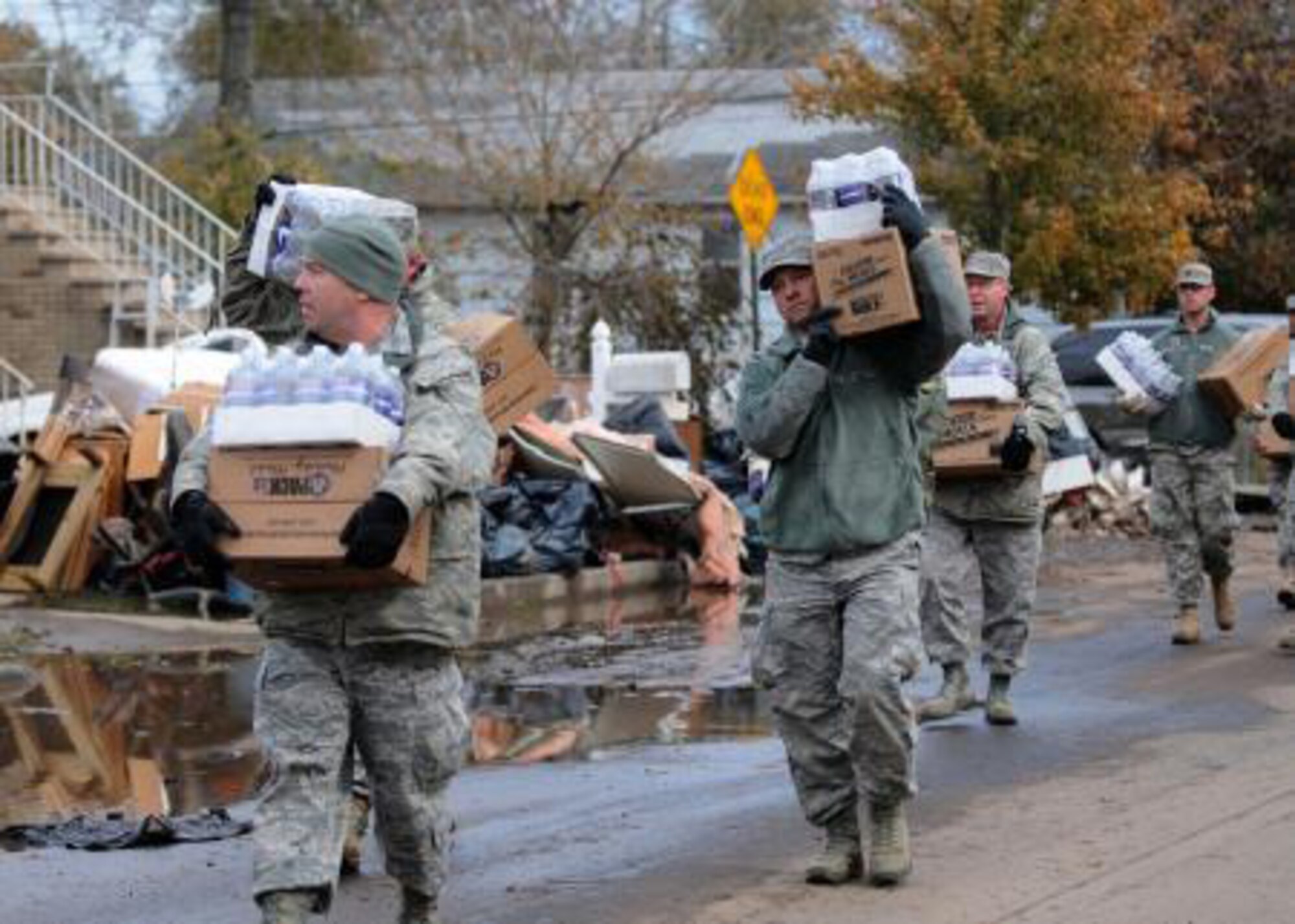 New York Air National Guard Master Sgt. Thomas Moade from the 174th Attack Wing out of Syracuse leads other members of the 174th as well as members of the New York Army Guard from Newburg in taking water and cases of food to local residents in Staten Island on Nov. 2. The food and water was provided to people who needed assistance after Hurricane Sandy took down power lines and caused massive destruction to many homes in the area leaving families desperate for help. Moade and the others were taking the food to those who could not make it to the Emergency Response location.