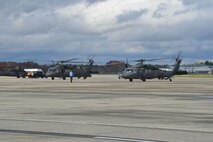 HANSCOM AIR FORCE BASE, Mass. – Two CH-47F Chinooks are guided into position on the flightline Oct. 31. The helicopters and their crew members are at Hanscom as part of the USNORTHCOM Defense Support of Civil Authorities mission that directs the command to plan and anticipate action that it may need to take to support civil authorities. USNORTHCOM plays an important role in disaster response; however, all efforts for Hurricane Sandy are in support of FEMA, working closely with state and local officials. (U.S. Air Force photo by Mark Herlihy)