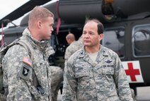 HANSCOM AIR FORCE BASE, Mass. – Col. Juan Gaud (right), 66th Air Base Group deputy commander, greets Maj. Andrew Dial, battalion operations officer, upon the 10th Mountain Division Combat Aviation Brigade’s arrival Oct. 31.Tthe brigade was positioned for possible hurricane relief support. (U.S. Air Force photo by Mark Herlihy)
