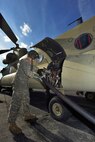HANSCOM AIR FORCE BASE, Mass. – Spc. Chad E. Messick, a CH-47F Chinook crew member, fuels the helicopter on the flightline Nov. 1. Four Chinooks, along with four UH-60 Blackhawks, and their crew members were moved to Hanscom in support of disaster response efforts for Task Force Phoenix of Fort Drum, N.Y. (U.S. Air Force photo by Walter Santos)