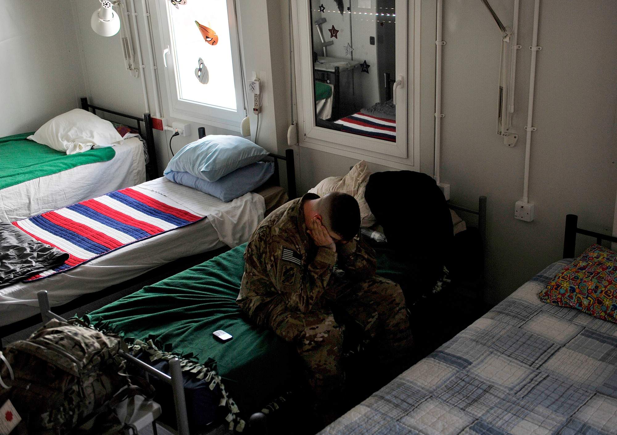 U.S. Army Sgt. Adam Stock, 396th Transportation Company, wakes up from a nap at the Contingency Aeromedical Staging Facility, Kandahar Airfield, Afghanistan, Oct. 22, 2012. Stock, a senior firefighter, injured his knee while deployed. He is deployed from Ft. Stewart, Ga. and is heading back to his unit after treatment to continue his deployment. The 651st CASF staff at Kandahar is 28 members strong and performs tasks ranging from helping medevac patients off of the helicopters they come in on to providing warm beds for their outgoing temporary residents. (U.S. Air Force photo/Staff Sgt. Clay Lancaster)