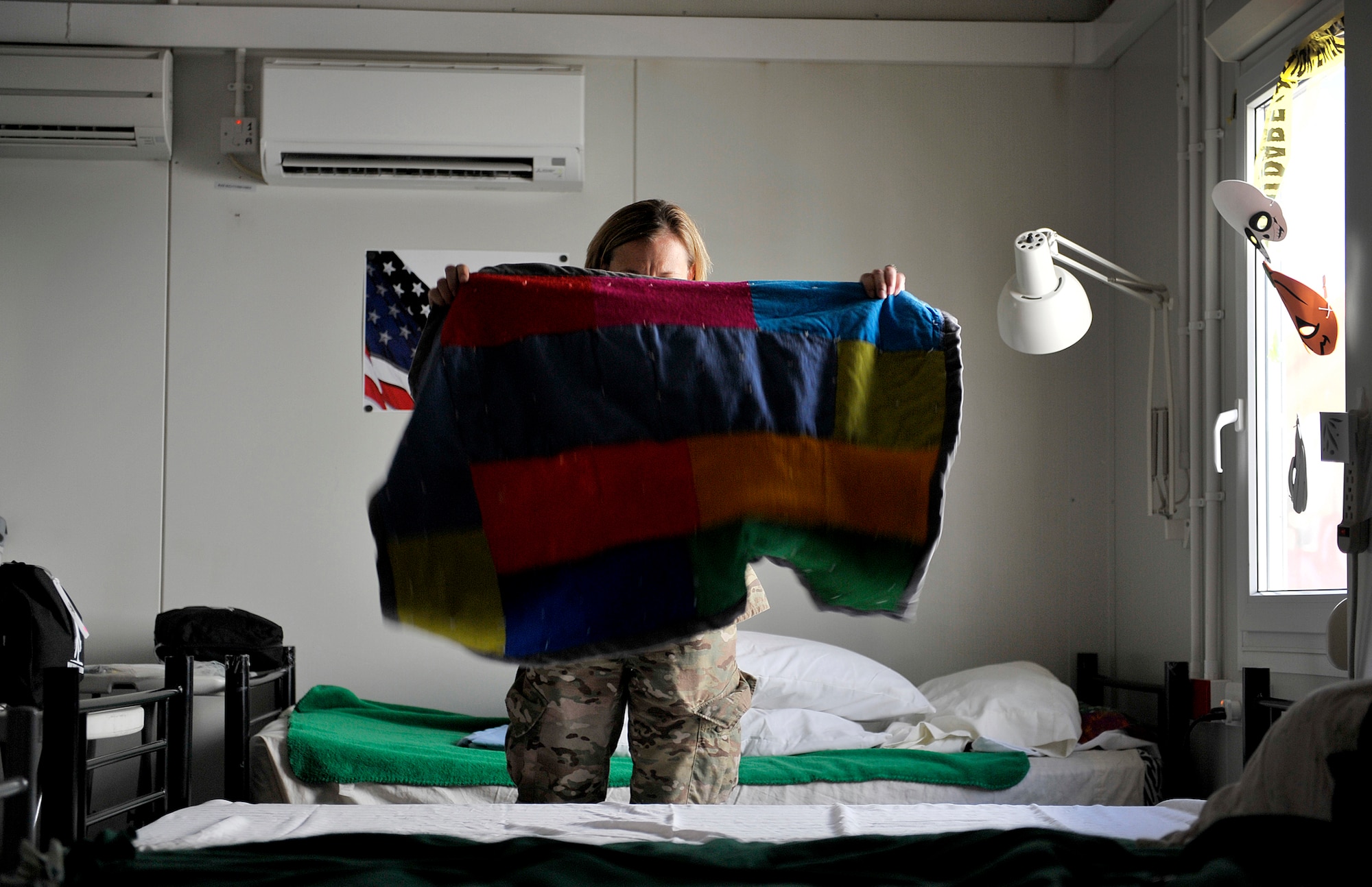 U.S. Air Force Capt. Jennifer Rhoades, Contingency Aeromedical Staging Facility senior nurse, 651st Expeditionary Aeromedical Evacuation Squadron, prepares one of nearly 20 patient beds during her day shift at the CASF compound, Kandahar Airfield, Afghanistan, Oct. 22, 2012. The 651st CASF staff at Kandahar is 28 members strong and performs tasks ranging from helping medevac patients off of the helicopters they come in on to providing warm beds for their outgoing temporary residents. (U.S. Air Force photo/Staff Sgt. Clay Lancaster)