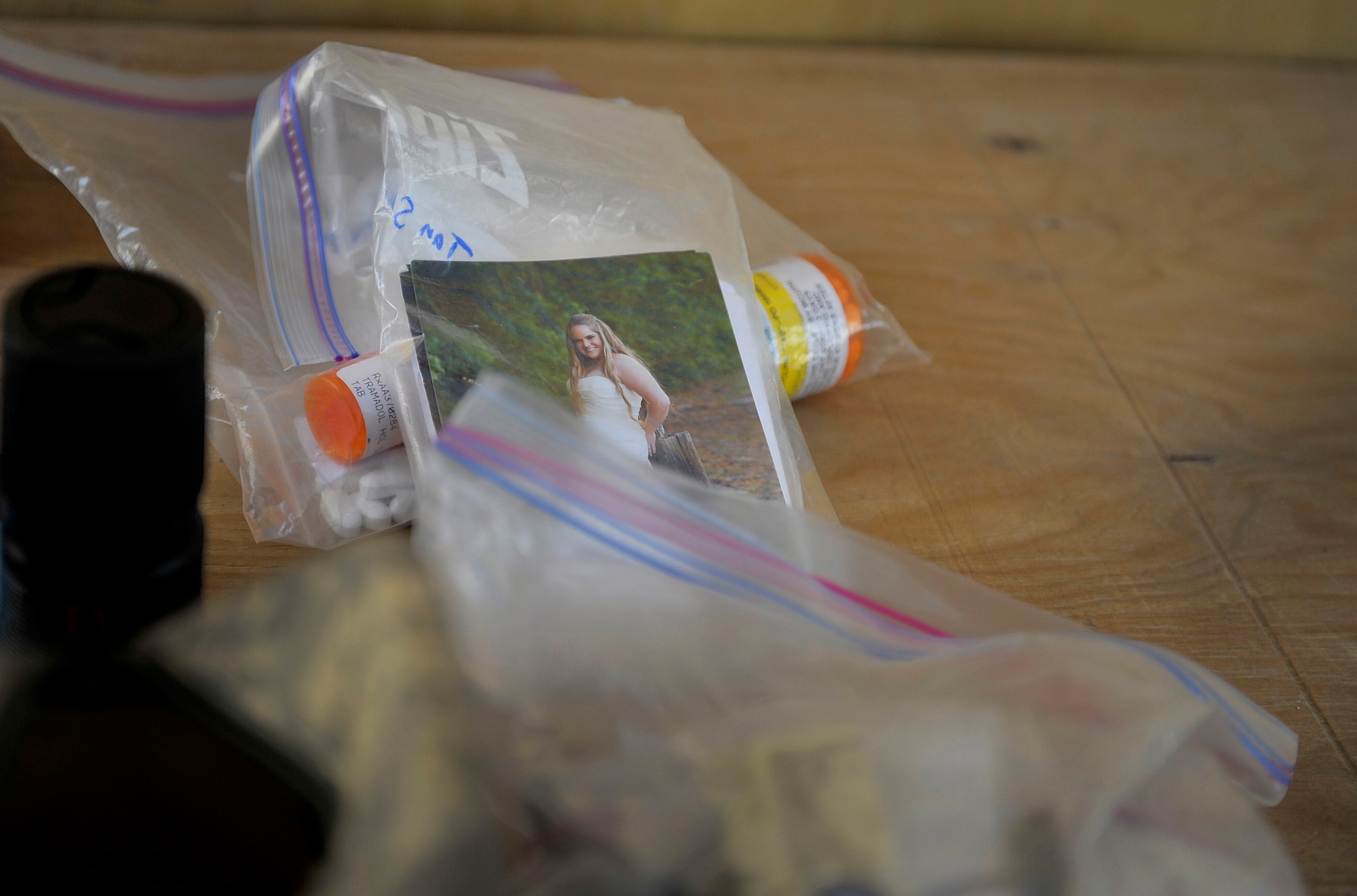 A picture of U.S. Army Sgt. Adam Stock's wife sits amid other luggage items after an anti-hijacking inspection at the Contingency Aeromedical Staging Facility, Kandahar Airfield, Afghanistan, Oct. 22, 2012. Stock, a senior firefighter, injured his knee while deployed. He is deployed from Ft. Stewart, Ga. and is heading back to his unit after treatment to continue his deployment. The 651st CASF staff at Kandahar is 28 members strong and performs tasks ranging from helping medevac patients off of the helicopters they come in on to providing warm beds for their outgoing temporary residents. (U.S. Air Force photo/Staff Sgt. Clay Lancaster)