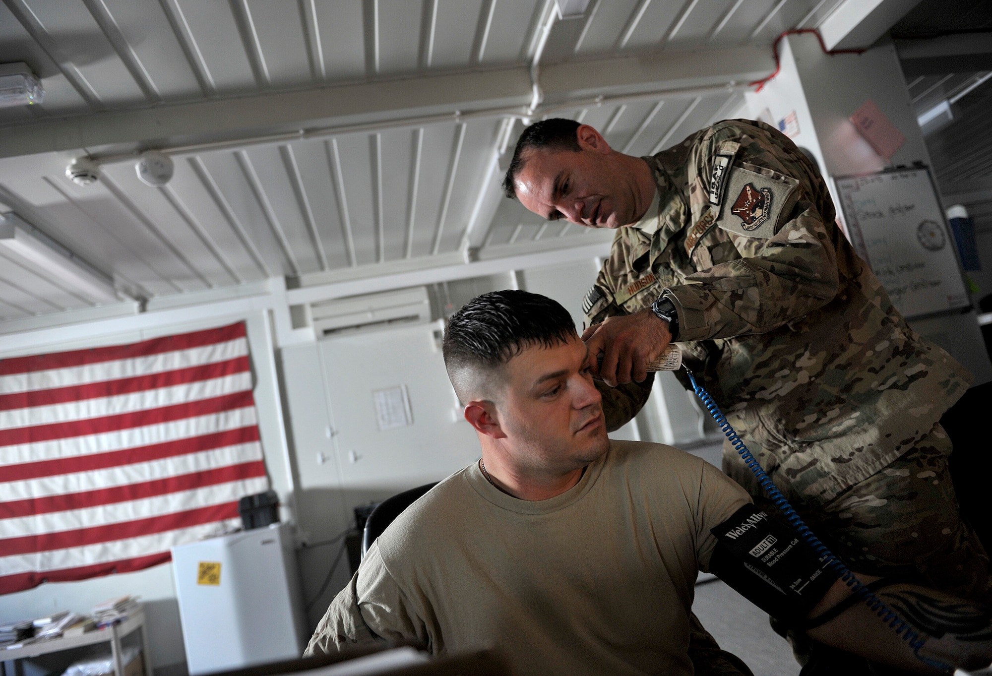 U.S. Air Force 1st Lt. Scott Hudson, Contingency Aeromedical Staging Facility nurse, 651st Expeditionary Aeromedical Evacuation Squadron, checks the vitals of Army Sgt. Adam Stock before an aeromedical evacuation flight at Kandahar Airfield, Afghanistan, Oct. 22, 2012. Stock, a senior firefighter, injured his knee while deployed. Stock is deployed from Ft. Stewart, Ga. and is heading back to his unit after treatment to continue his deployment. The 651st CASF staff at Kandahar is 28 members strong and performs tasks ranging from helping medevac patients off of the helicopters they come in on to providing warm beds for their outgoing temporary residents. (U.S. Air Force photo/Staff Sgt. Clay Lancaster)