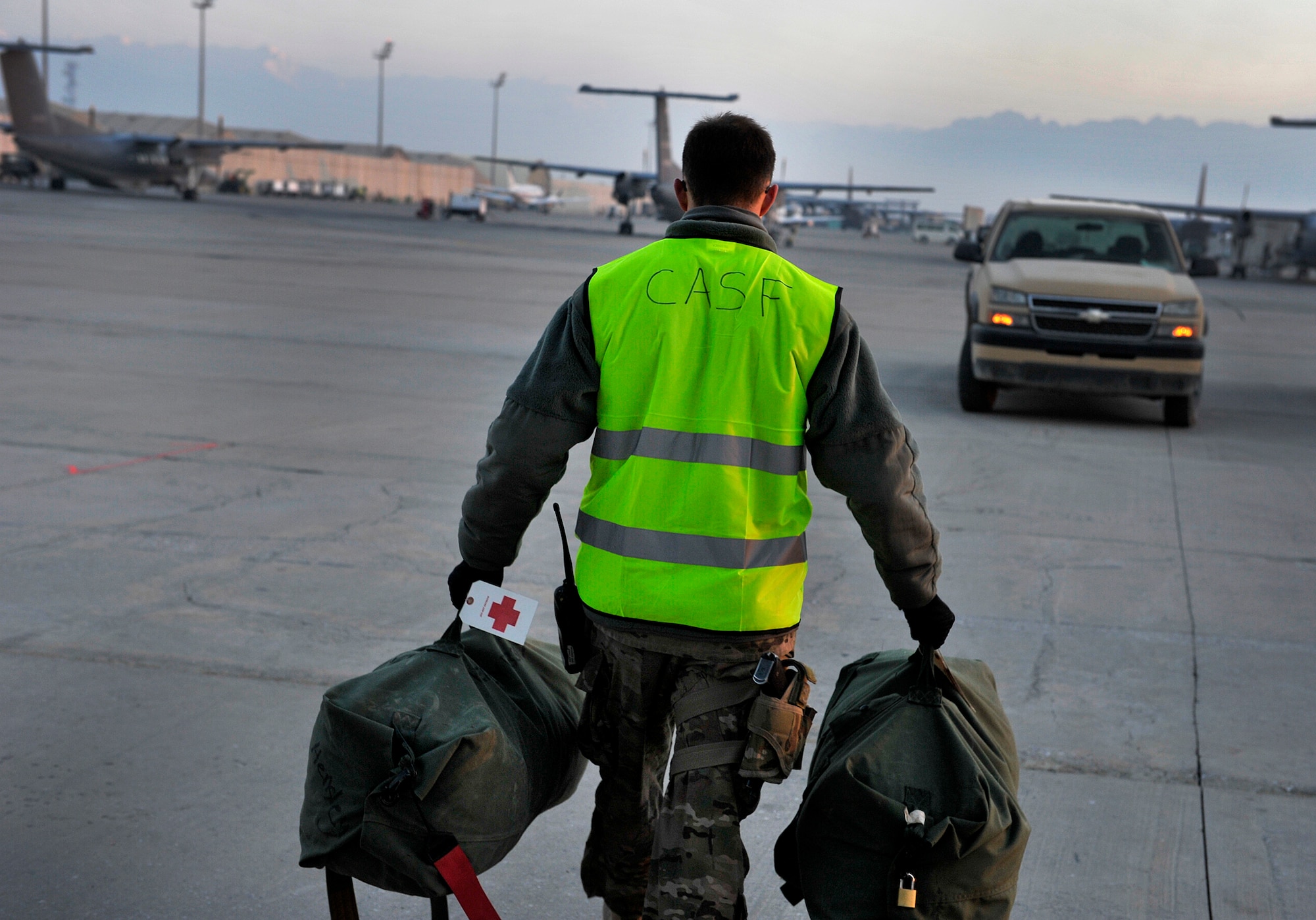A U.S. Air Force Contingency Aeromedical Staging Facility member carries patients??? luggage during an aeromedical evacuation mission at Bagram Airfield, Afghanistan, Oct. 21, 2012. The aeromedical flights are used to transport injured or recovered patients with the NATO Role 3 hospital and the CASF based at Kandahar Airfield. The CASF staff at Kandahar is 28 members strong and performs tasks ranging from helping medevac patients off of the helicopters they come in on to providing warm beds for their outgoing temporary residents. (U.S. Air Force photo/Staff Sgt. Clay Lancaster)