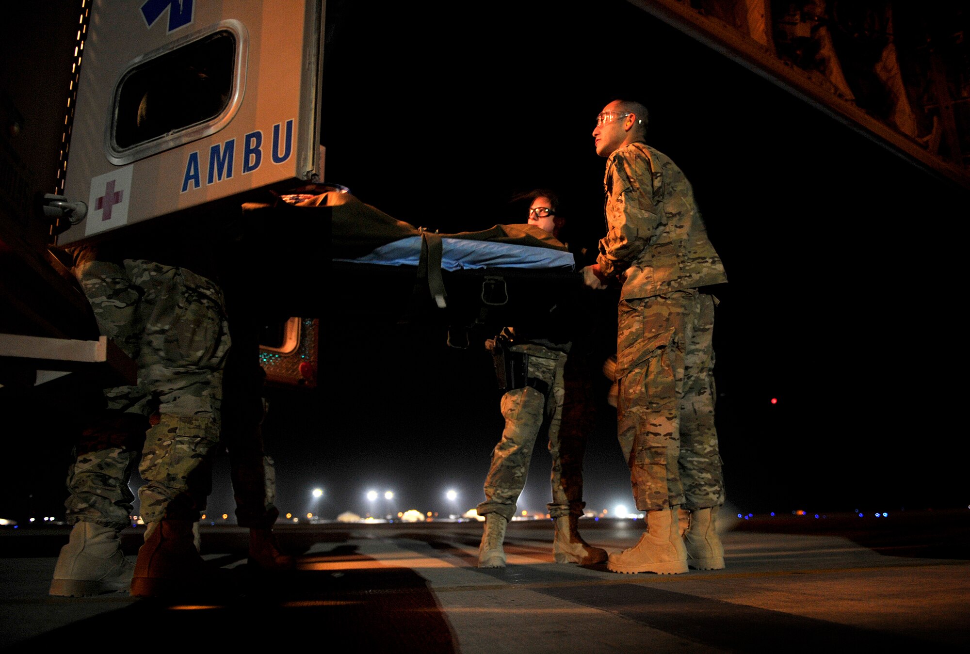 U.S. Air Force members transport an injured patient onto a C-130 Hercules during an aeromedical evacuation mission at Camp Bastion, Afghanistan, Oct. 21, 2012. The aeromedical flights are used to transport injured or recovered patients with the NATO Role 3 hospital and the Contingency Aeromedical Staging Facility based at Kandahar Airfield. The CASF staff at Kandahar is 28 members strong and performs tasks ranging from helping medevac patients off of the helicopters they come in on to providing warm beds for their outgoing temporary residents. (U.S. Air Force photo/Staff Sgt. Clay Lancaster)