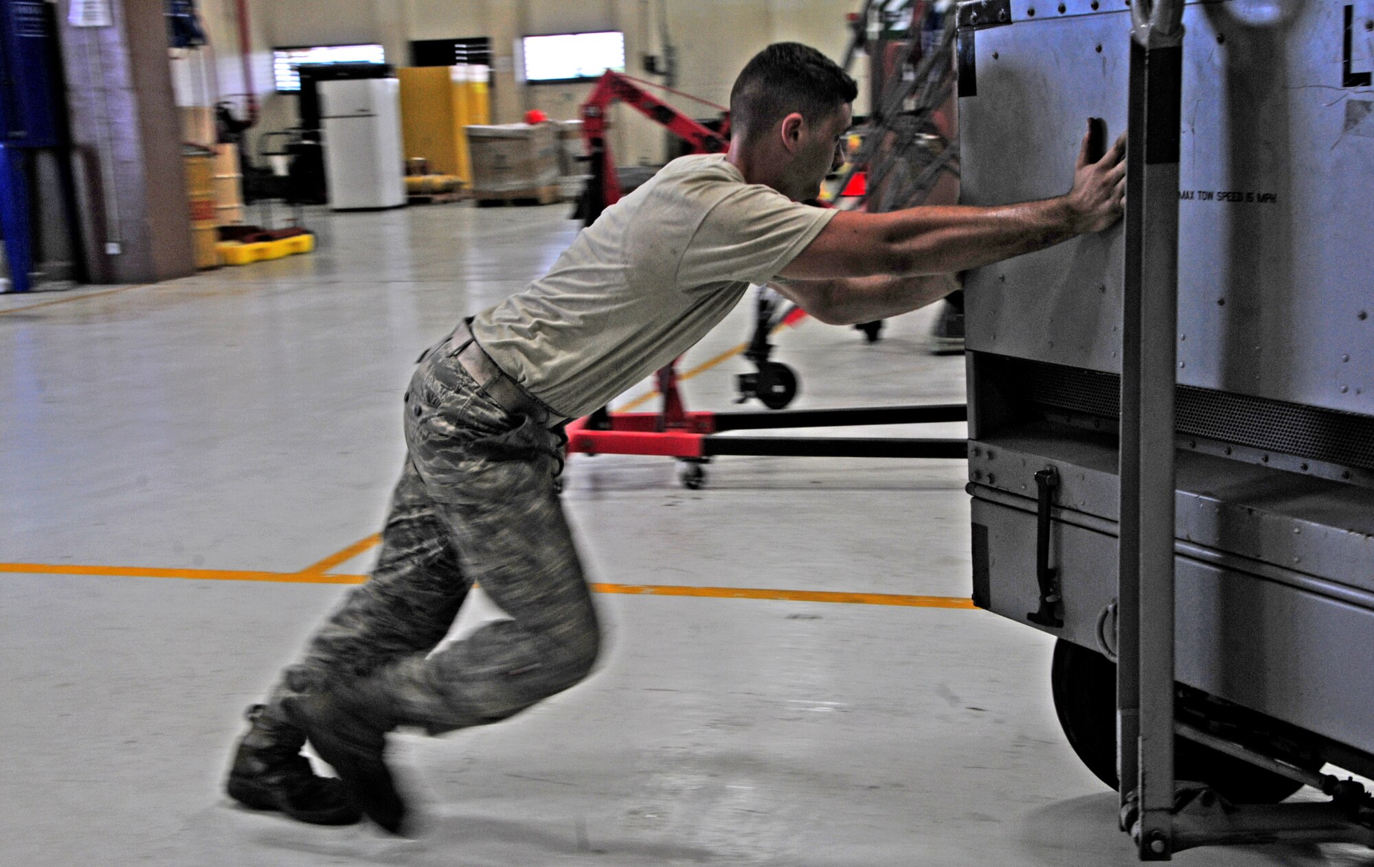 Airman 1st Class Andrew Caprio, 3rd Maintenance Squadron aerospace ground equipment flight journeyman, pushes an air-start cart to his work area at Andersen Air Force Base, Oct. 30. Airman Caprio is deployed to Andersen from Joint Base Elmendorf-Richardson, Alaska. (U.S. Air Force photo/Airman 1st Class Marianique Santos/Released)