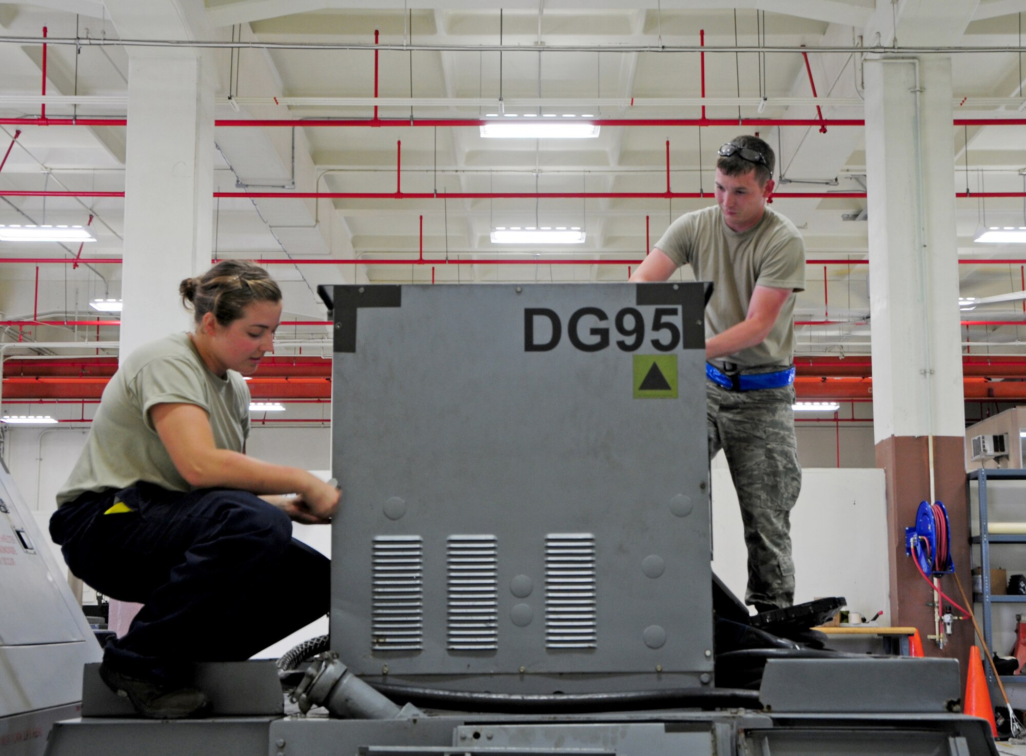 ANDERSEN AIR FORCE BASE, Guam – Airman 1st Class Alexandra Ayers (left) and Airman 1st Class Ty Vaughn, 3rd Maintenance Squadron aerospace ground equipment flight journeymen, perform maintenance on a generator at Andersen Air Force Base, Guam, Oct. 30. The Airmen are deployed to Andersen Joint Base Elmendorf-Richardson, Alaska. (U.S. Air Force photo/Airman 1st Class Marianique Santos/Released)