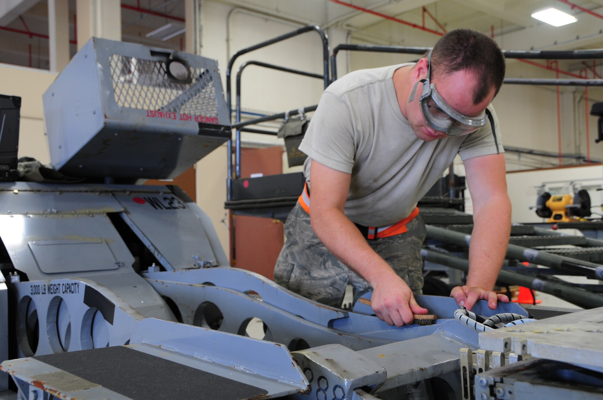 ANDERSEN AIR FORCE BASE, Guam – Senior Airman Joshua Hershberg, 3rd Maintenance Squadron aerospace ground equipment flight journeyman, conducts corrosion control on a bomb lift at Andersen Air Force Base, Guam, Oct. 30. Airman Hershberg is deployed to Andersen from Joint Base Elmendorf-Richardson, Alaska. (U.S. Air Force photo/Airman 1st Class Marianique Santos/Released)