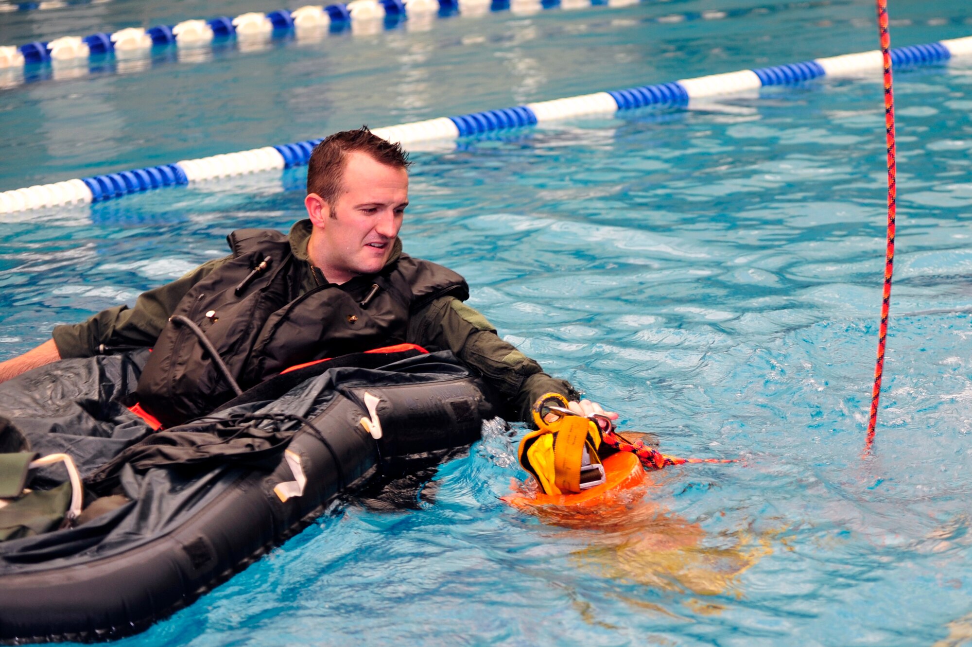 Capt. Ricky Greer, 36th Fighter Squadron pilot, prepares for recovery in a water survival evaluation at the Osan Air Base pool, Nov. 5, 2012. Osan’s Survival Evasion Resistance and Escape instructors work to refresh pilots’ water survival skills by allowing them to demonstrate their knowledge on their equipment, wildlife hazards and how to signal for recovery. (U.S. Air Force photo/Airman 1st Class Alexis Siekert)