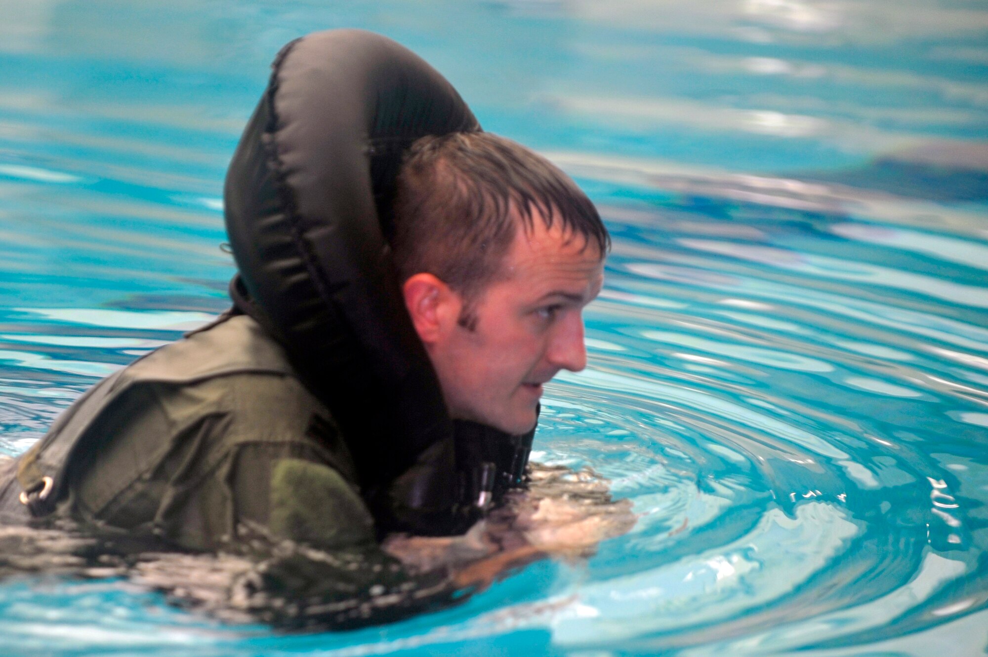 Capt. Ricky Greer, 36th Fighter Squadron pilot, goes through water survival training at the Osan Air Base pool, Nov. 5, 2012, during exercise Beverly Bulldog, 13-02. Osan’s two Survival, Evasion, Resistance and Escape instructors evaluate pilots during base exercises to allow evaluators to assess their instruction methods. Pilots are required to receive follow-up training on water survival every three years. (U.S. Air Force photo/Airman 1st Class Alexis Siekert)
