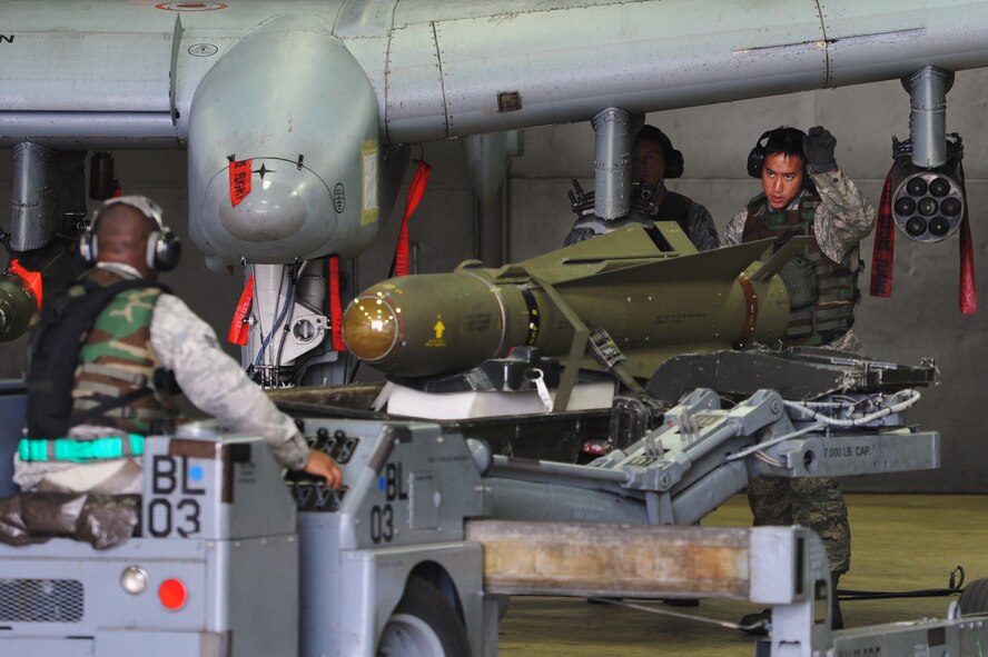 Senior Airman Eugene Davis, Senior Airman Matthew Lugeanbeal and Staff Sgt. Paolo Santos, 25th Aircraft Maintenance Unit weapons loader, load munitions onto an A-10 Thunderbolt II during operational readiness exercise Beverly Bulldog 13-01 at Osan Air Base, Republic of Korea, Nov. 5, 2012. The exercise tests Osan Airmen’s abilities during a heightened state of readiness while providing combat ready forces for close air support, air strike control, counter air, interdiction, theater airlift, and communications in the defense of the Republic of Korea. (U.S. Air Force photo/Staff Sgt. Craig Cisek) 
