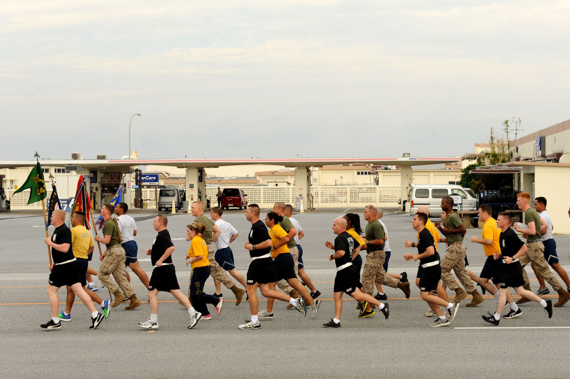 Law enforcement Airmen, Marines, Sailors and Soldiers run together for the annual Special Olympics Torch Run on Kadena Air Base, Japan, Nov. 3, 2012. The torch run began in 1981 when law enforcement officers in Wichita, Kan. saw the need to raise funds for Special Olympics. The 13th Annual Kadena Special Olympics is scheduled for Nov. 17. (U.S. Air Force photo/Airman 1st Class Brooke P. Beers)