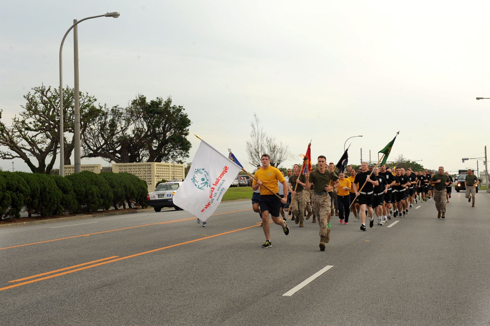Law enforcement Airmen, Marines, Sailors and Soldiers run together for the annual Special Olympics Torch Run on Kadena Air Base, Japan, Nov. 3, 2012. The run was to commemorate the 13th Annual Kadena Special Olympics Games that is scheduled for Nov. 17. (U.S. Air Force photo/Airman 1st Class Brooke P. Beers)
