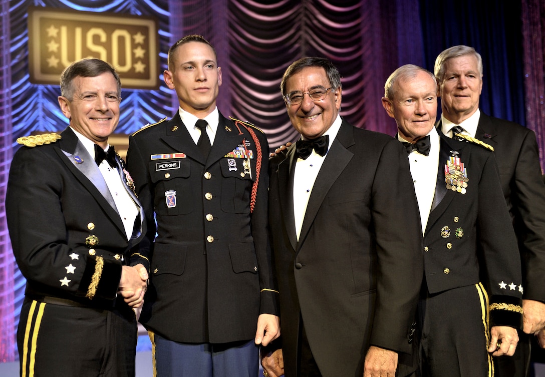 Army Lt. Gen. William Troy, left, director of Army staff, Defense Secretary Leon E. Panetta, center, Army Gen. Martin E. Dempsey, chairman of the Joint Chiefs of Staff, right, and retired Air Force Gen. Richard B. Myers, far right, former chairman of the Joint Chiefs of Staff, present the USO Soldier of the Year award to Marine Corps Staff Sgt. Jacob J. Perkins, second from left, during the 2012 USO Gala at the Washington Hilton in Washington, D.C., Nov. 2, 2012.