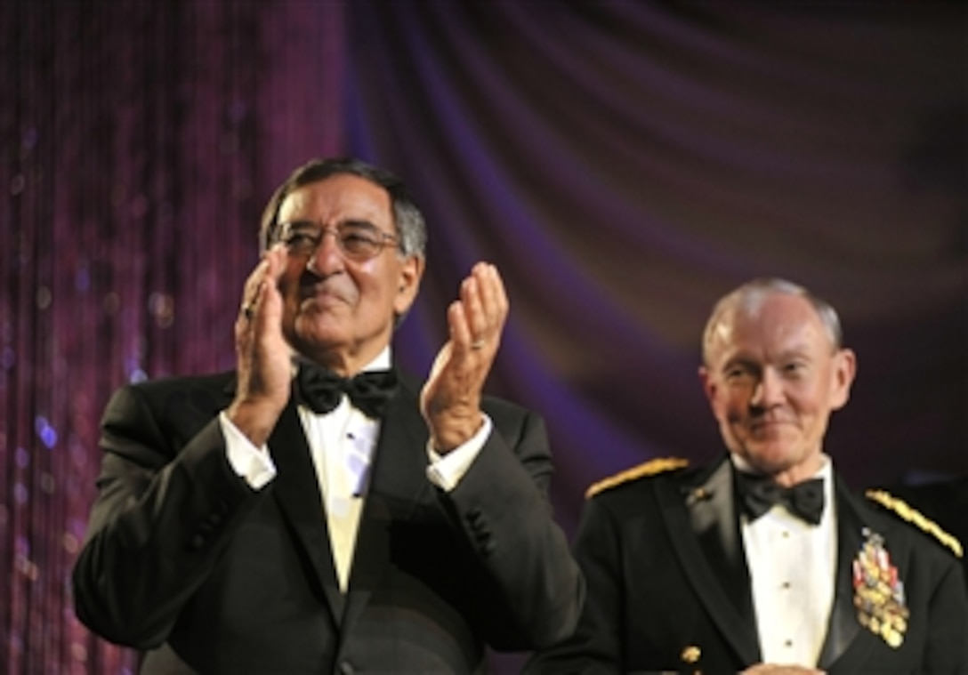 Secretary of Defense Leon E. Panetta, left, applauds as service members of the year are introduced at the 2012 USO Gala in Washington, D.C., on Nov. 2, 2012.  Chairman of the Joint Chiefs of Staff Gen. Martin E. Dempsey, right, joined Panetta on stage for the introductions.  