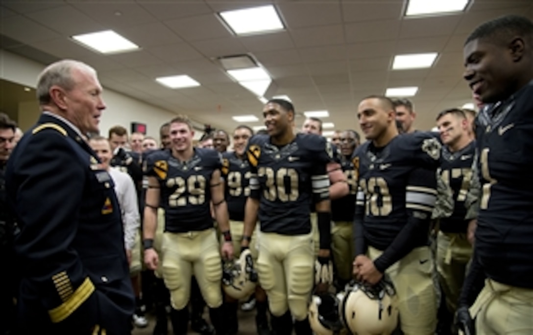 Chairman of the Joint Chiefs of Staff Gen. Martin E. Dempsey, left, speaks with West Point football players in the locker room after their win over Air Force in West Point, N.Y., on Nov. 3, 2012.  The Army Black Knights won the game by a score of 41 to 21.  